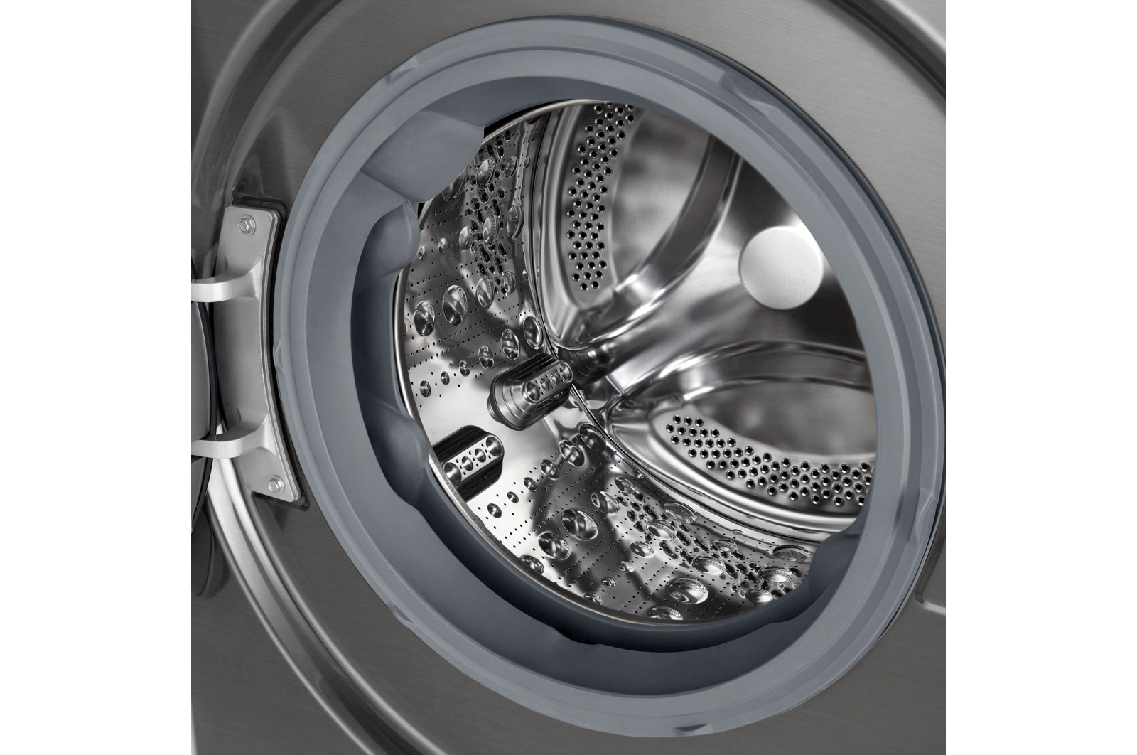 Zbliżenie bębna pralki. Bęben jest ze stali nierdzewnej z centralnym mieszadłem.