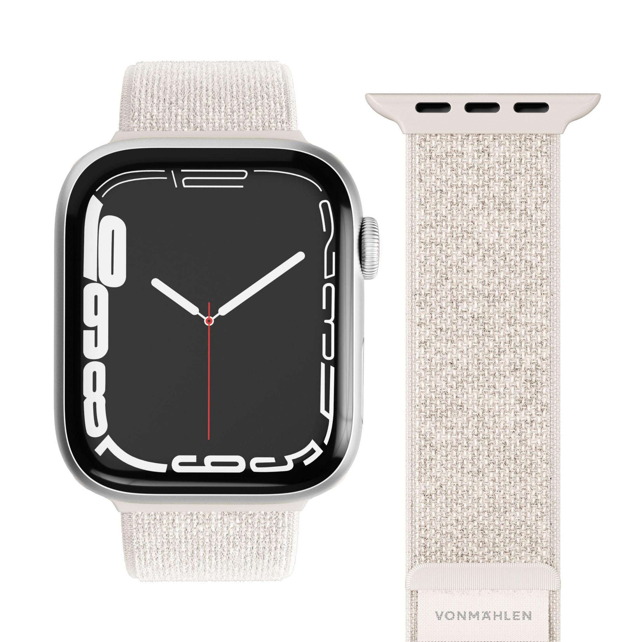 Srebrny Apple Watch z paskiem z tkaniny i pasującym paskiem obok.