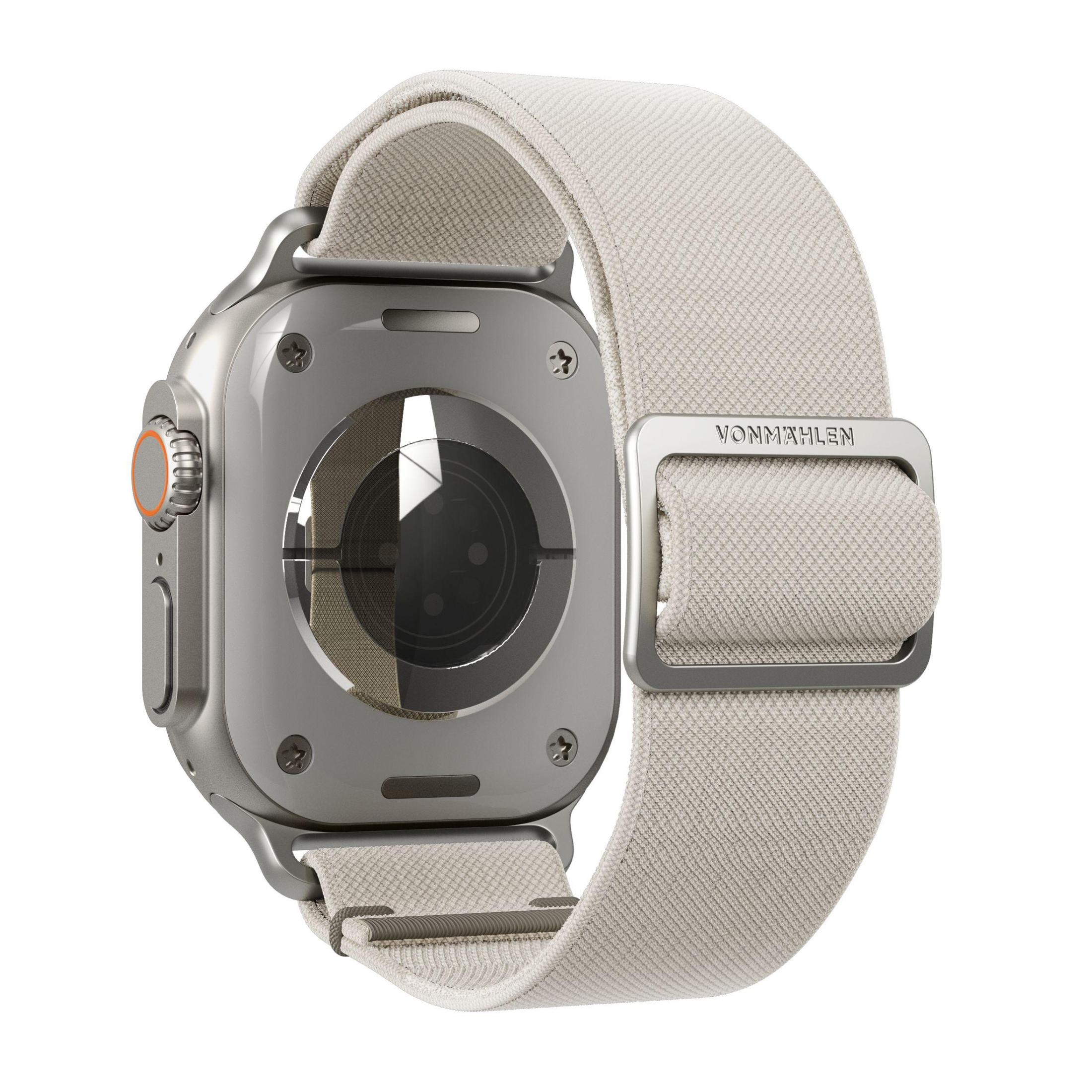 Srebrny Apple Watch Ultra z białym paskiem, widok z tyłu. Klamra z napisem VONMAHLEN.