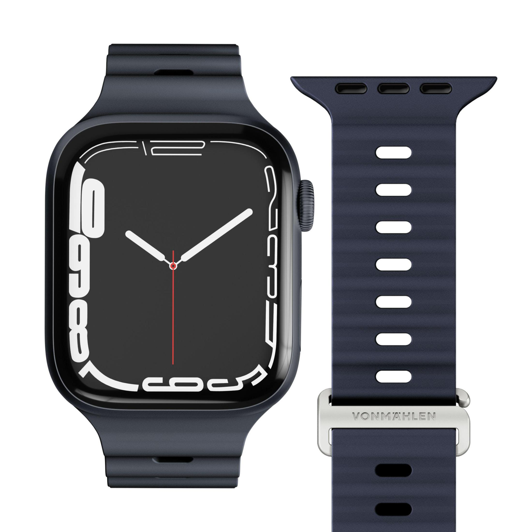 Ciemnoniebieski smartwatch z pasującym paskiem obok.