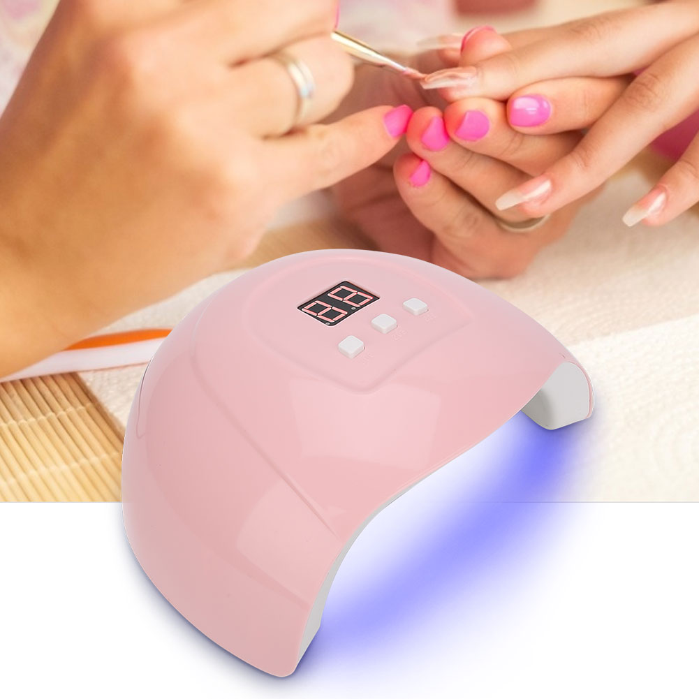 Eine pinke Nagellampe mit einer Maniküre. Die Lampe hat eine Anzeige mit Zahlen und Knöpfen.