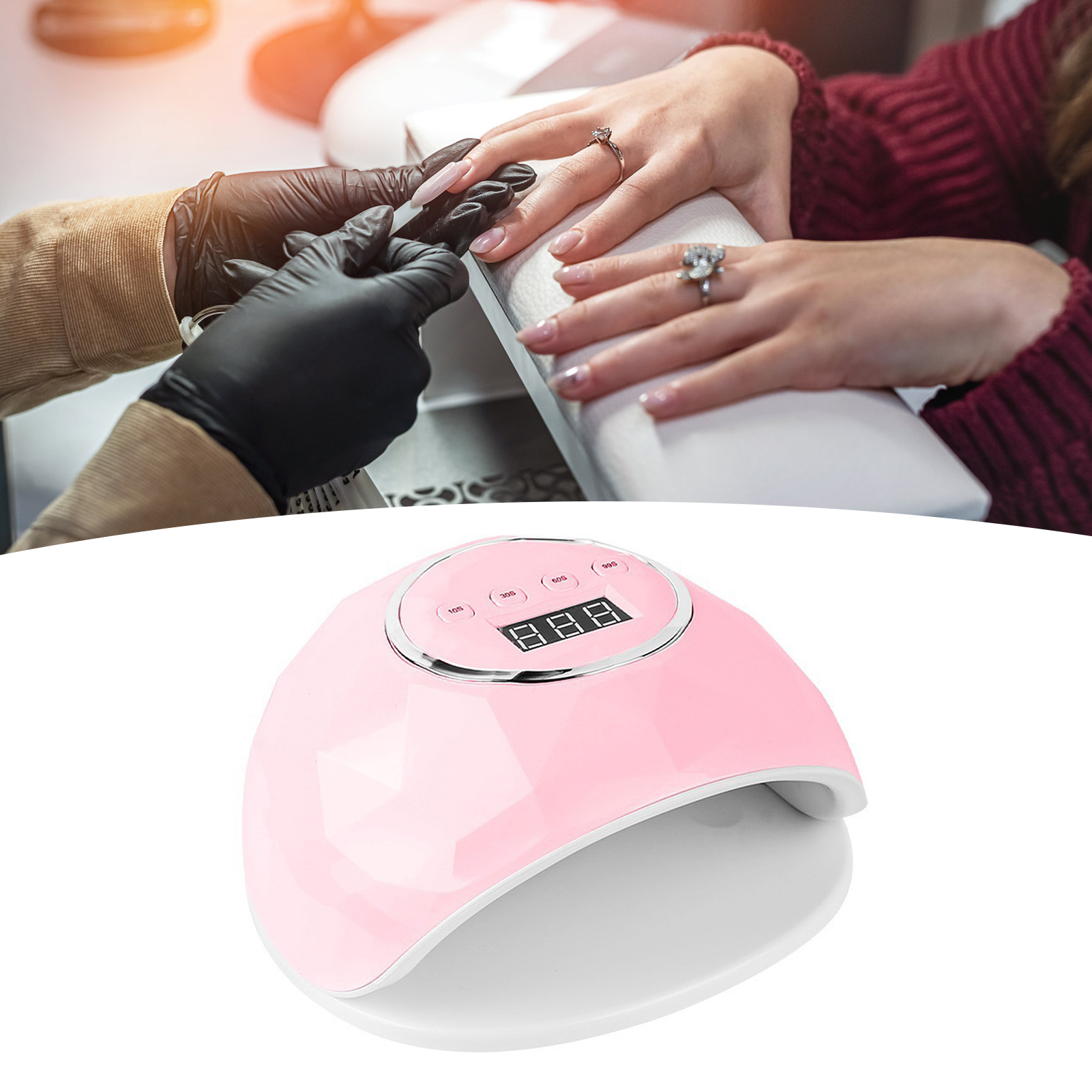 Eine rosa Nagellampe mit einer Hand und einer Maniküre im Gange.