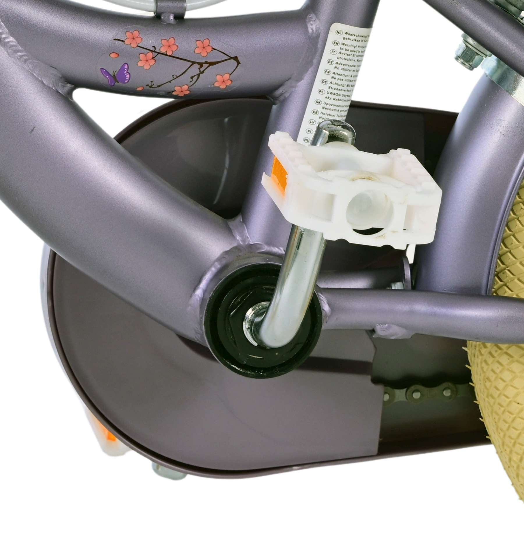 Nahaufnahme des Rahmens eines Kinderfahrrads, zeigt Pedal, Kettenschutz und lila Rahmen.