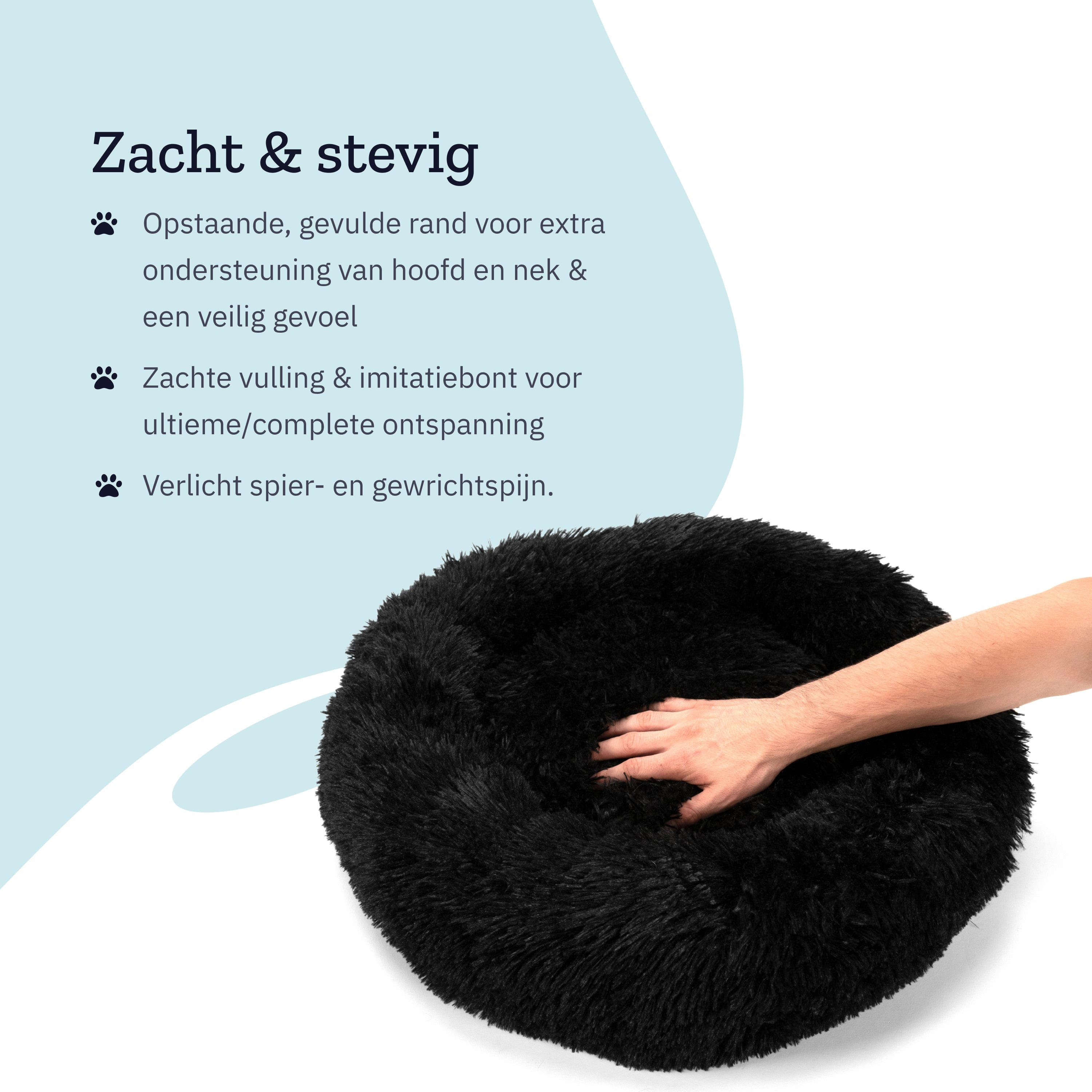 Black dog bed with a soft, fluffy surface. A hand is touching the bed, indicating its softness.