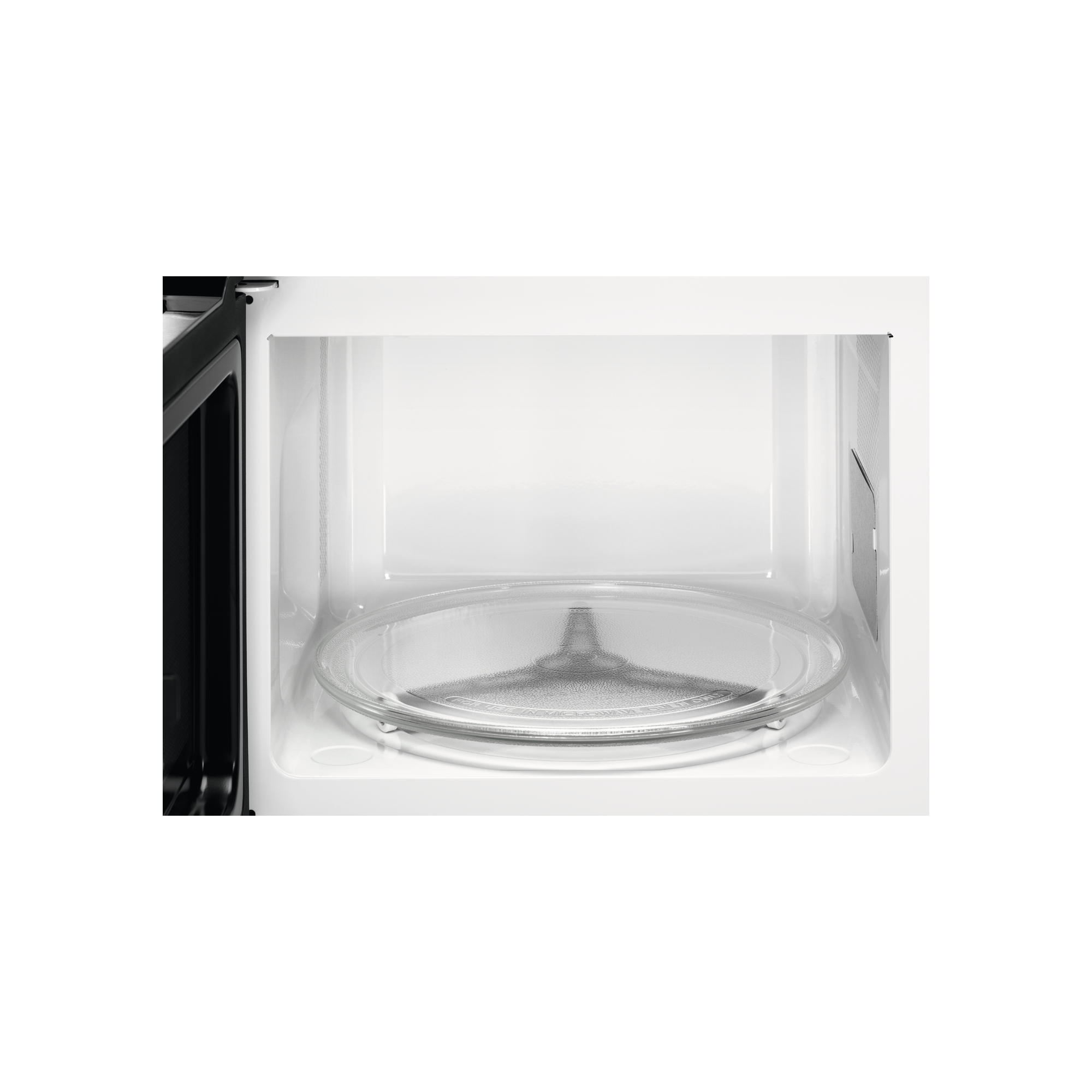 Interno di un forno a microonde. Un piatto di vetro è visibile al centro. L'interno è bianco.