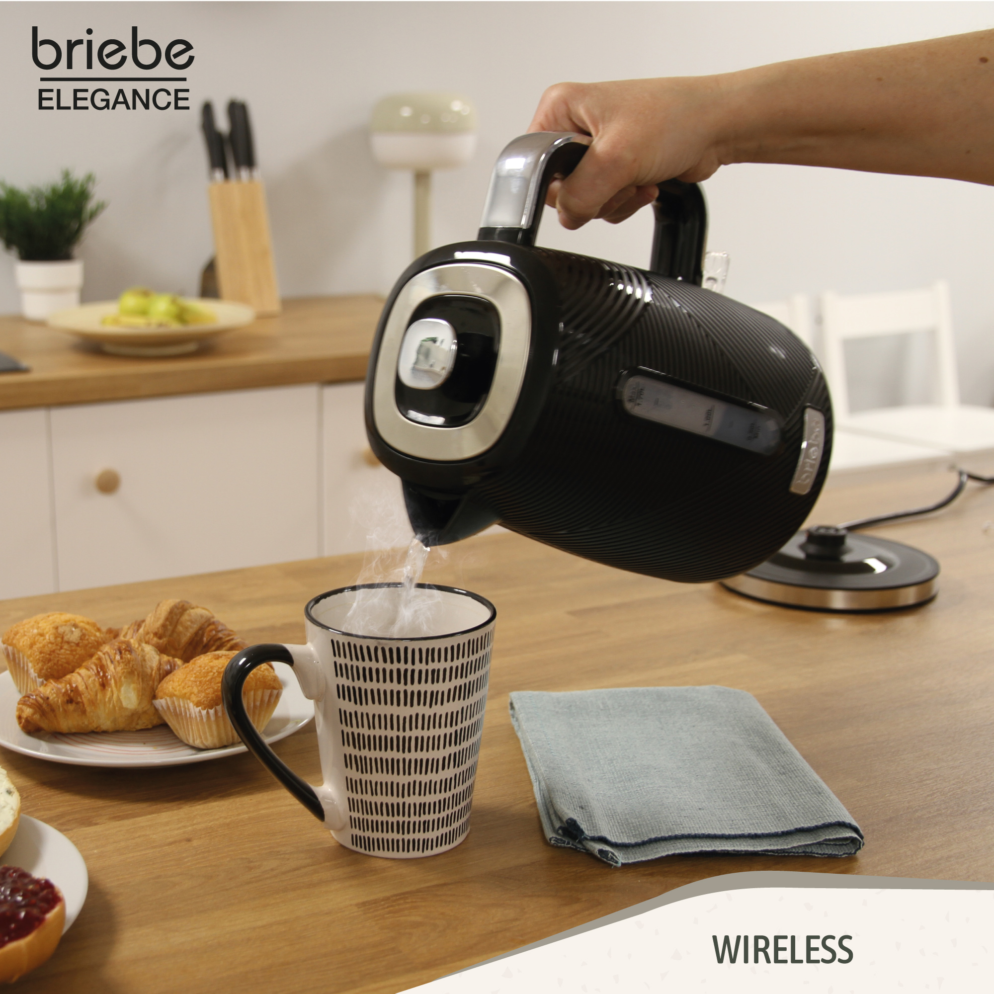 Una persona vierte agua de una tetera eléctrica negra en una taza. Comida y una toalla cerca.