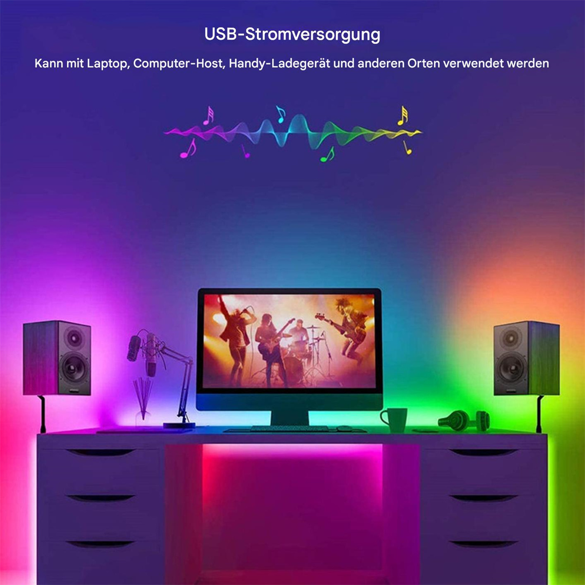 Ein Schreibtisch mit Computer, Lautsprechern und bunten LED-Leuchten. Text: "USB-Stromversorgung" mit Noten.