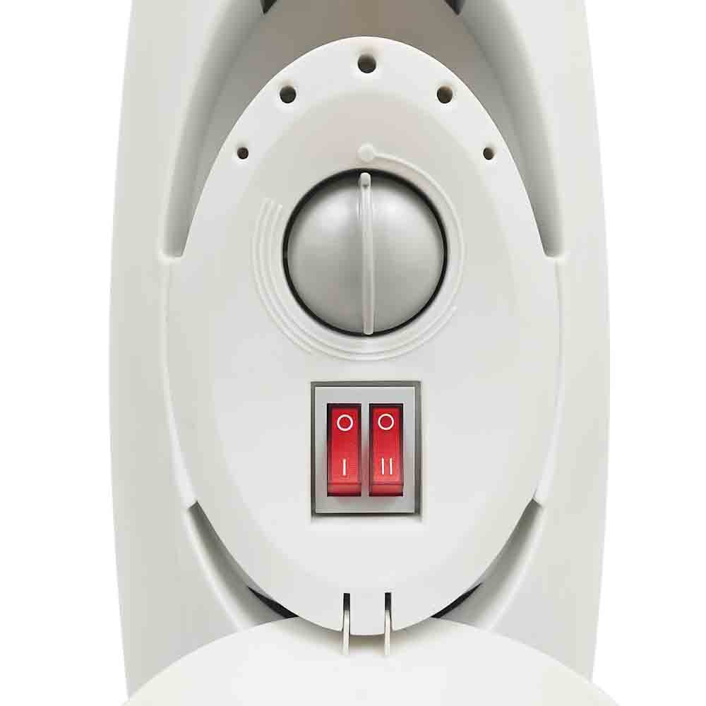 Primer plano del panel de control de un calentador eléctrico. Dos interruptores rojos y un dial.