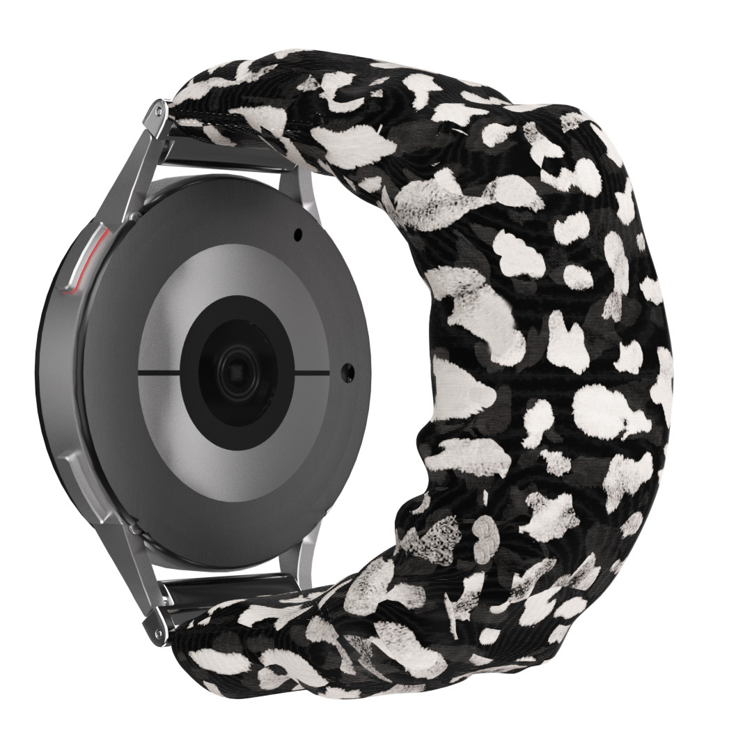 Eine Smartwatch mit gemustertem Armband. Das Band hat weiße Punkte auf schwarzem Hintergrund. Die Rückseite.
