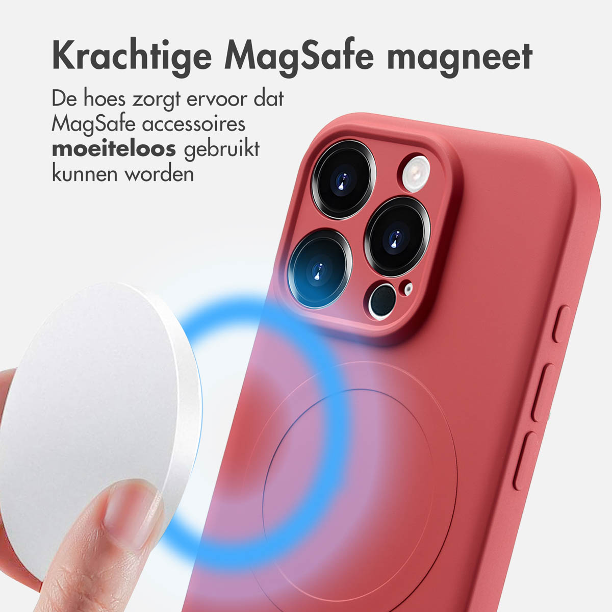 Rode telefoonhoes met een MagSafe-ring, een witte schijf en een telefoon die door een hand wordt vastgehouden. Blauwe achtergrond.