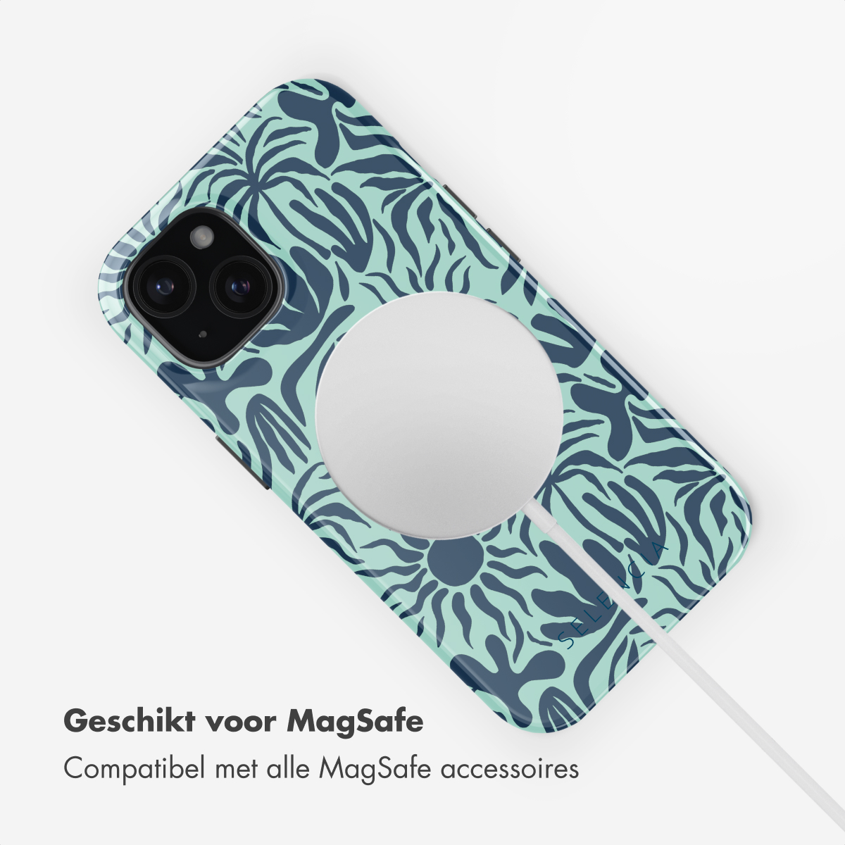 Phone with a blue and green pattern case. The phone is on a white charger with a white background.