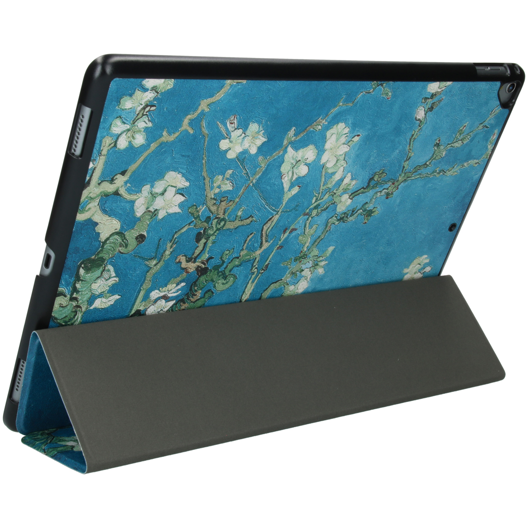 An iPad with a floral case is propped up. The case has a blue background and white flower details.