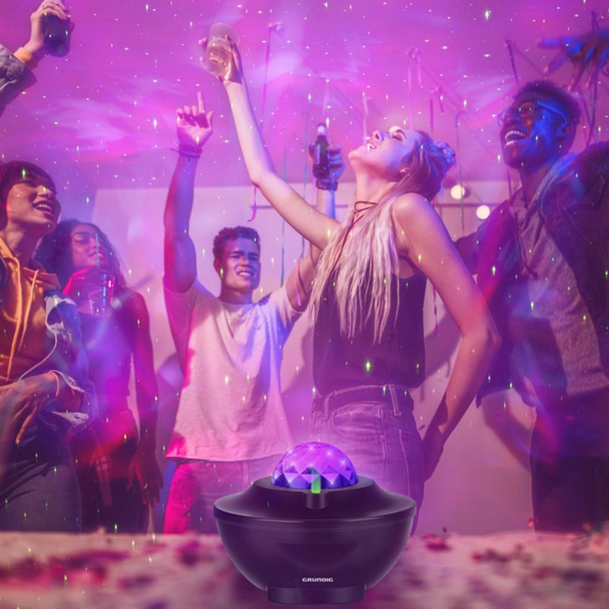 People in a party scene with a disco light projector.