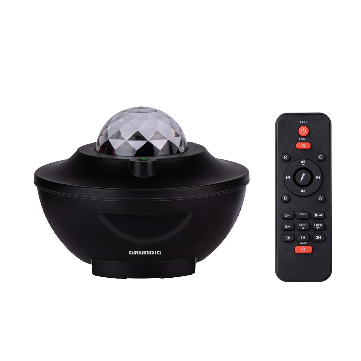 A black and white Grundig star projector and a black remote are on a white surface.