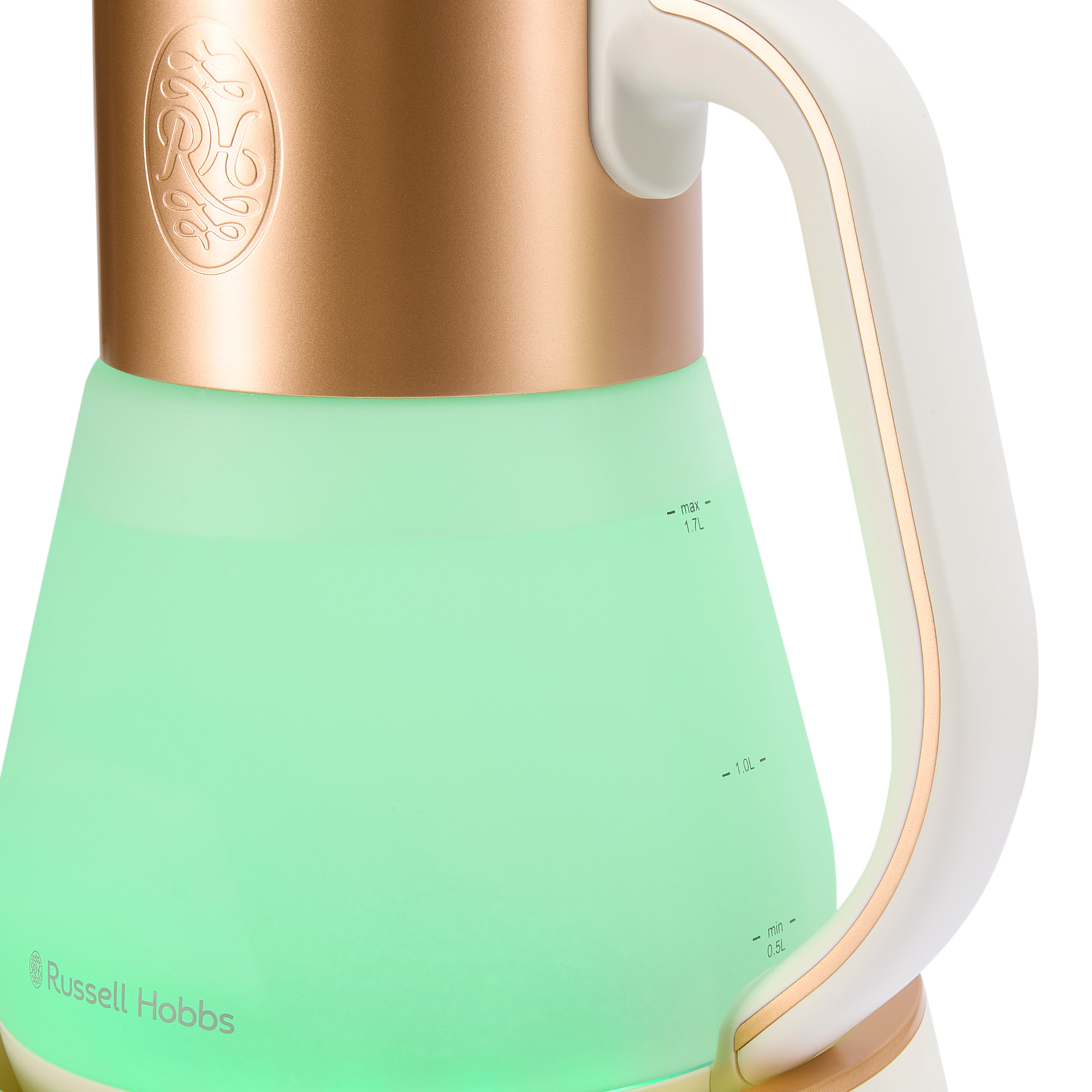 Un bollitore bianco e oro con una luce verde all'interno. Il manico è bianco.