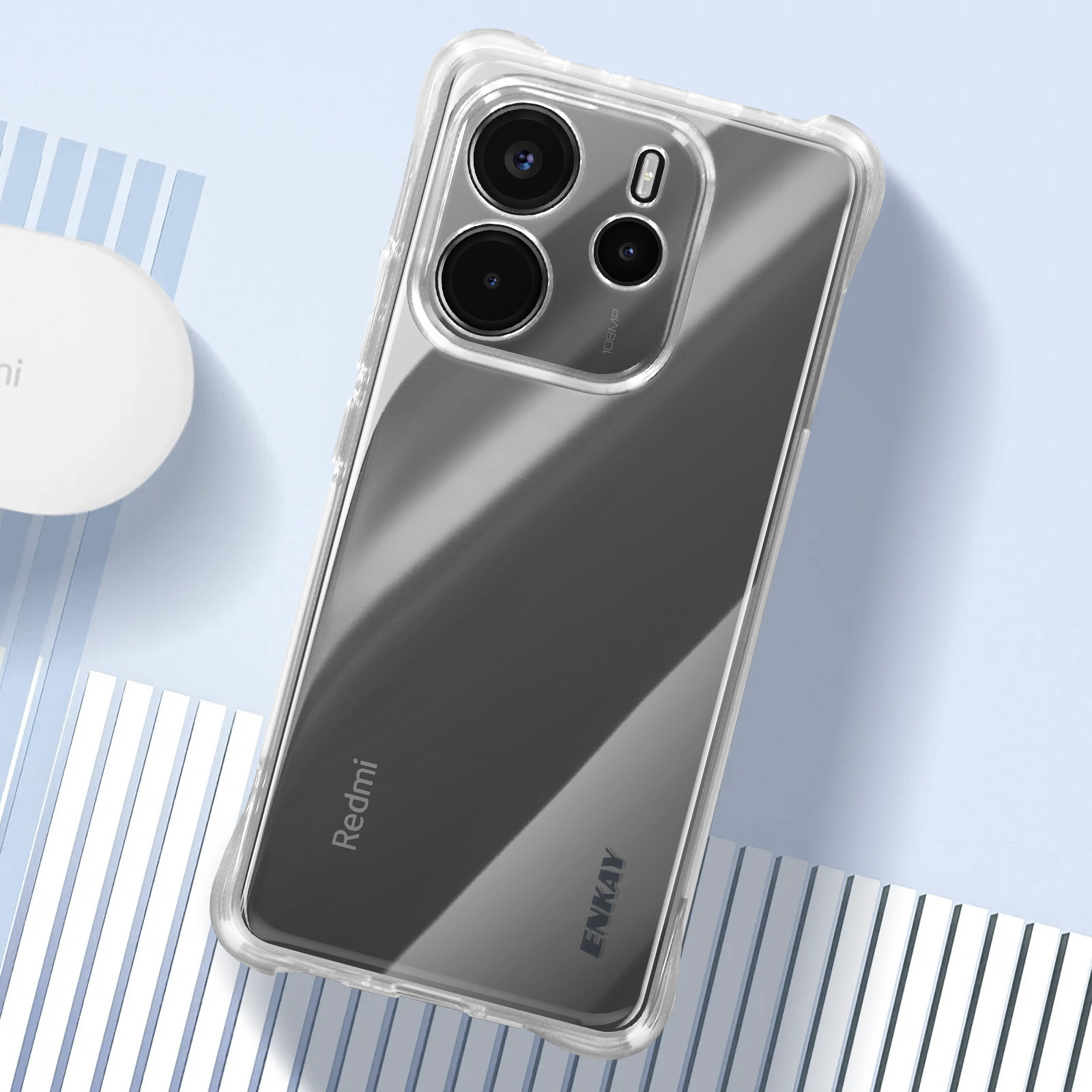 Telefoon in een doorzichtige hoes. Tekst: 108MP, ENKAY en Redmi labels zichtbaar. Transparant ontwerp.