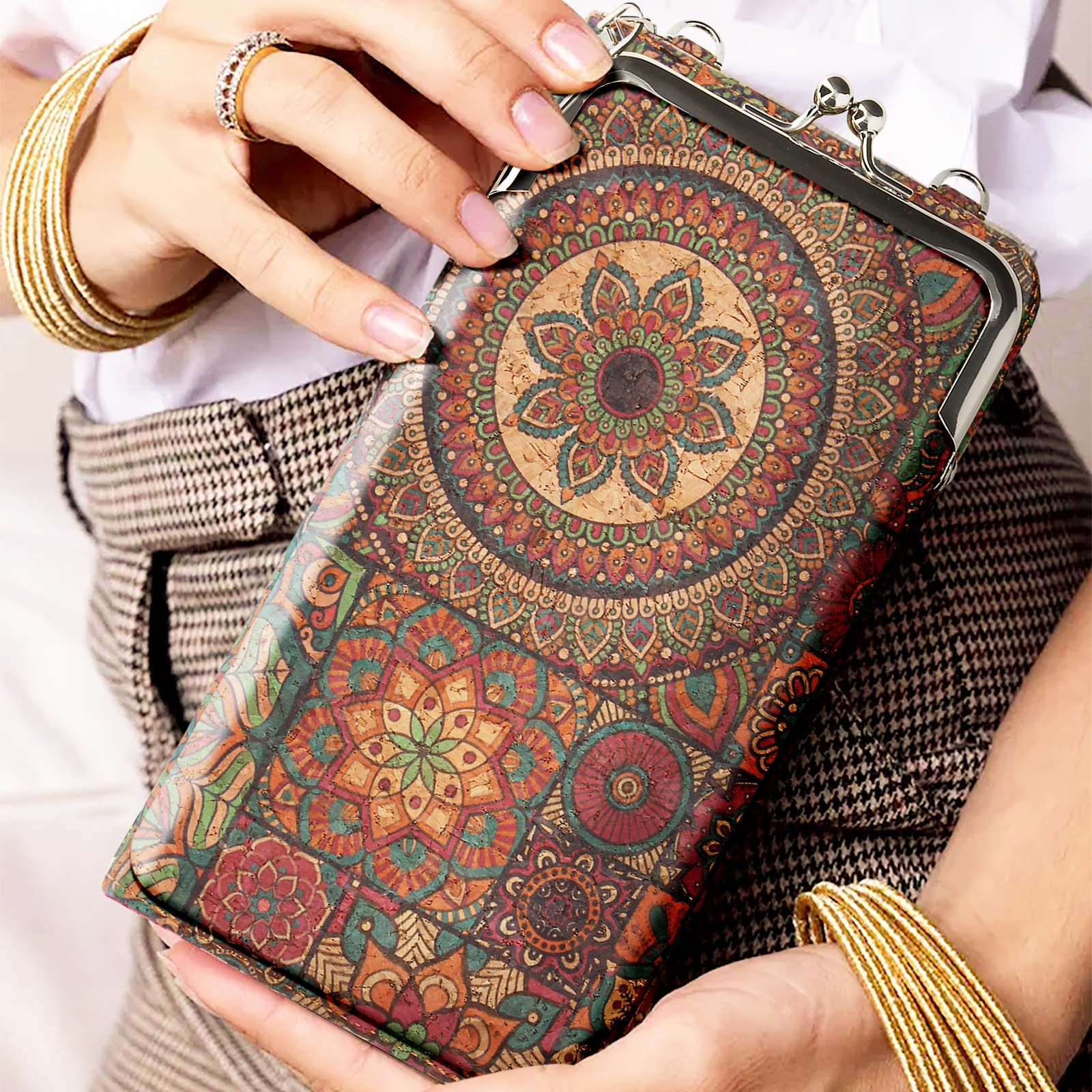 Eine Frau hält eine gemusterte Clutch. Die Clutch hat ein kreisförmiges Design und einen Metallverschluss.