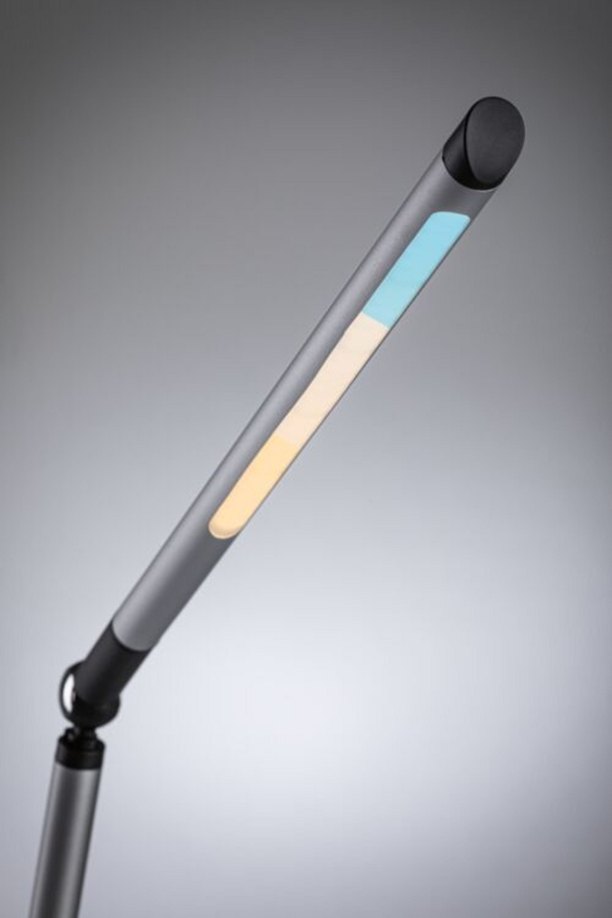 Lampada da scrivania grigia e nera con una barra luminosa. Lo sfondo è grigio.