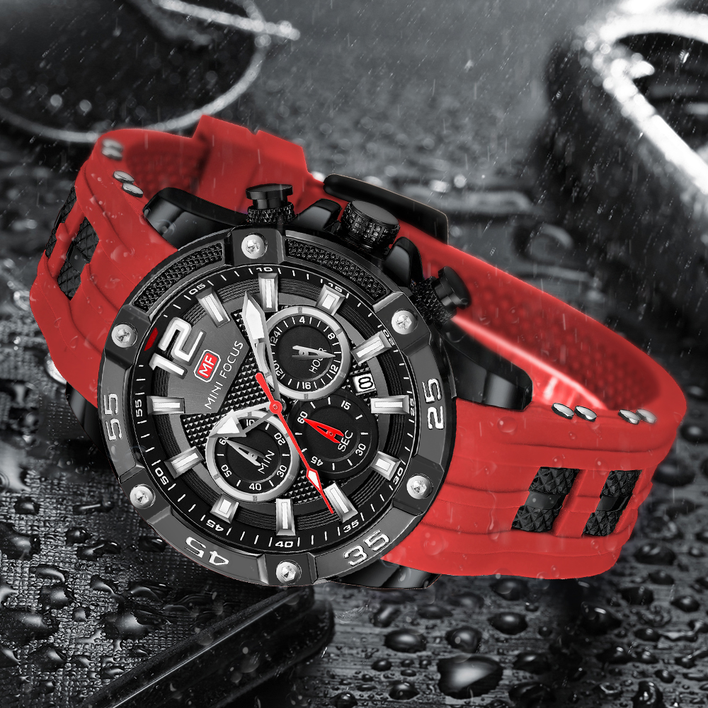 Schwarze und rote Uhr mit rotem Armband, Regentropfen im Hintergrund.