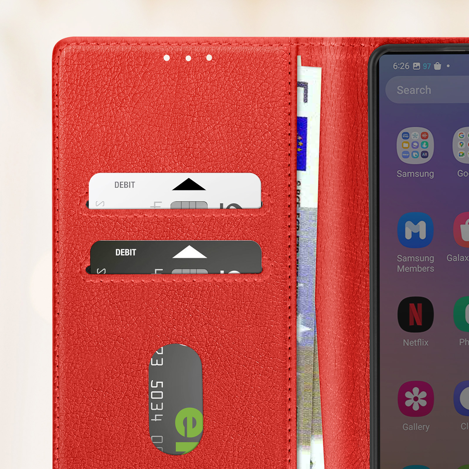 Primo piano di una custodia rossa per telefono aperta, con carte di debito, contanti e schermo.