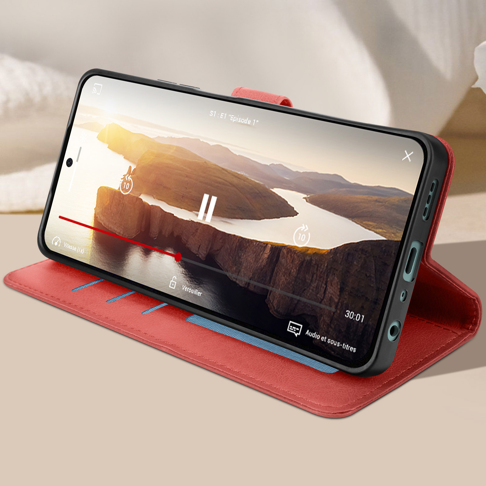 Telefono in custodia rossa, che mostra un video di un albero e tramonto.