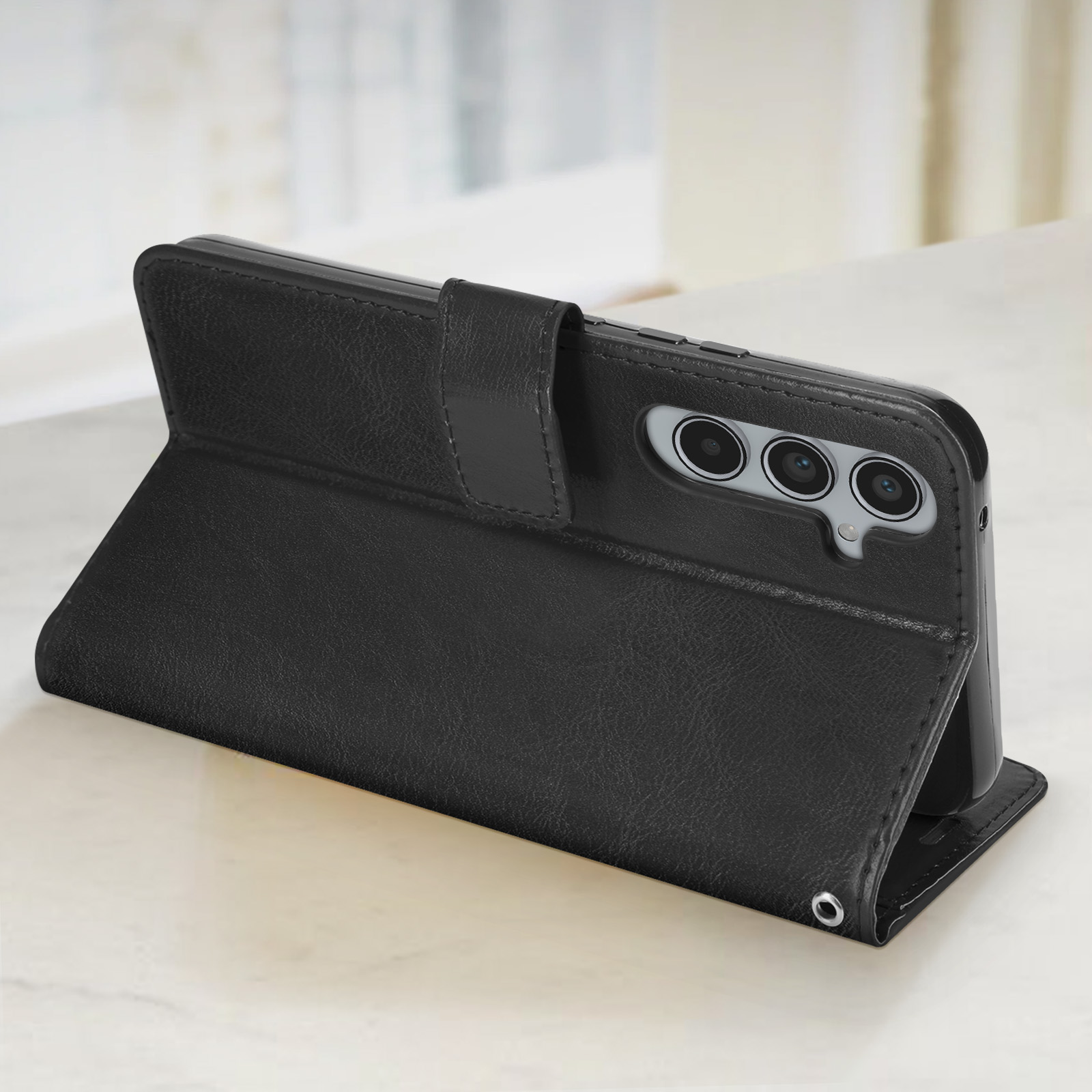 Custodia per telefono nera, chiusa. Caratteristiche: tre fotocamere e una chiusura magnetica.