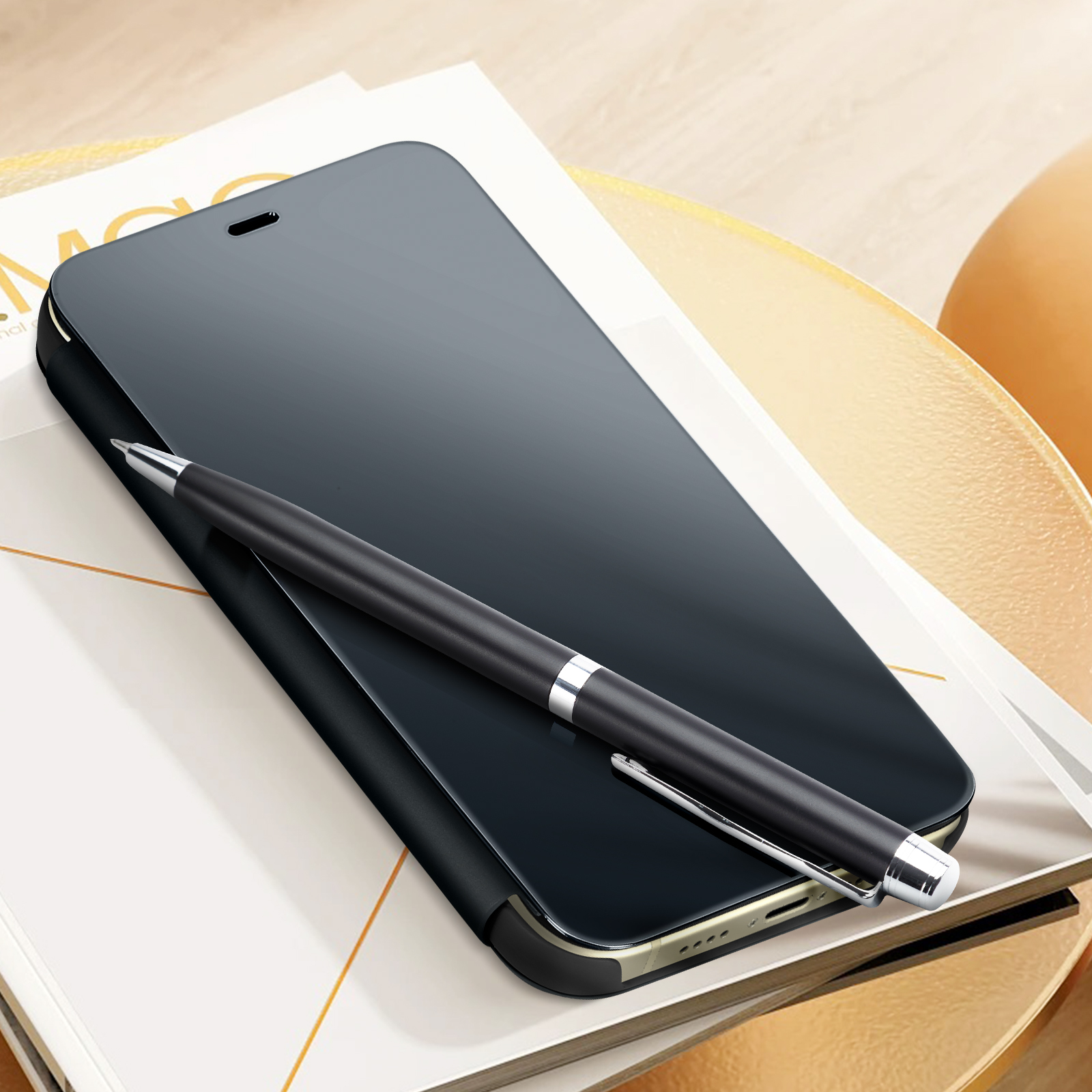 Uno smartphone nero e una penna su una superficie bianca. Il telefono è rivolto verso l'alto.