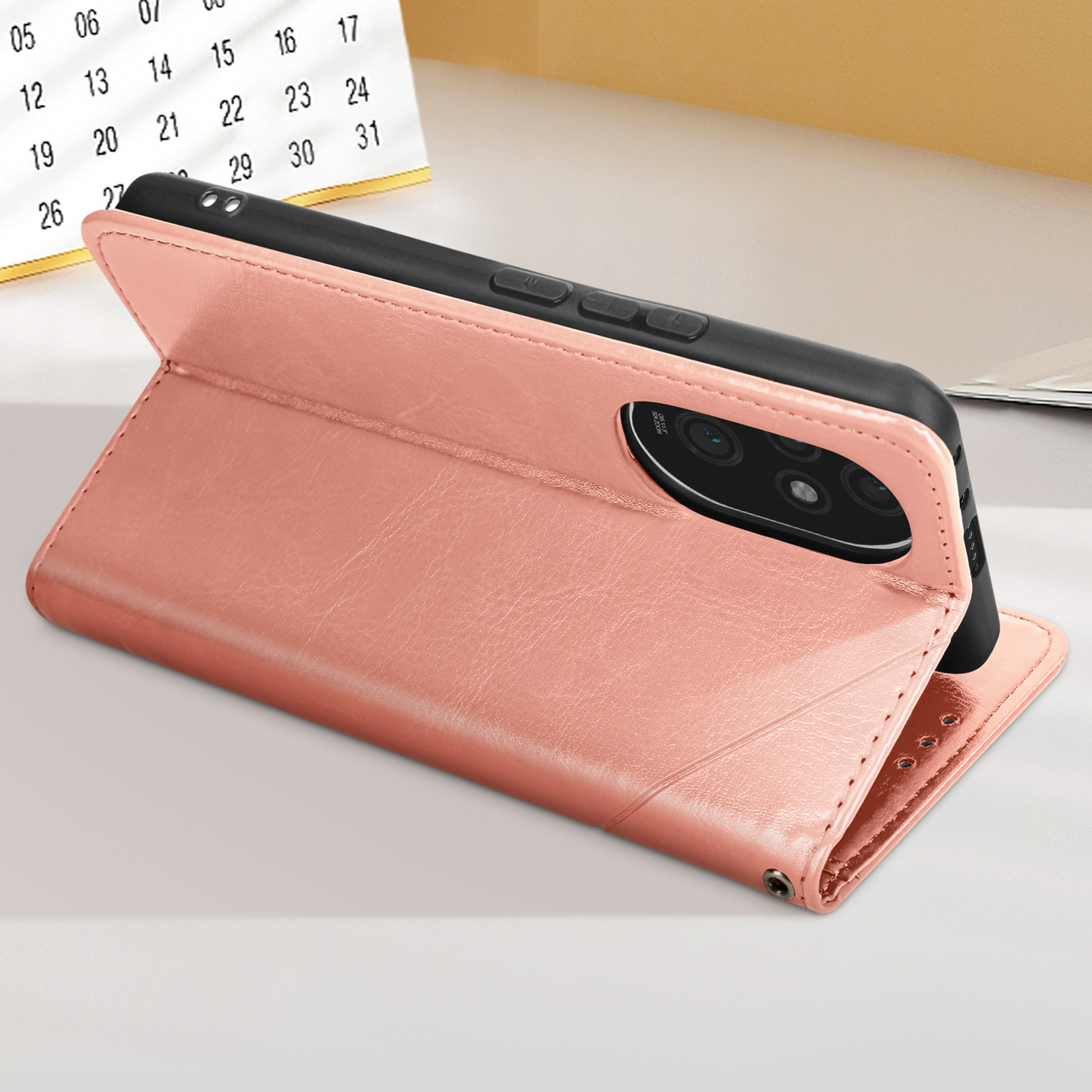 Custodia rosa per telefono con un telefono all'interno. La custodia è aperta. Sfondo: calendario e superficie.