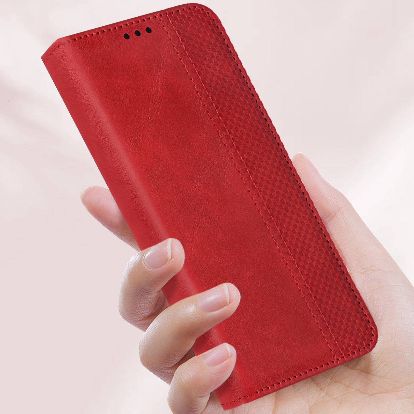 Custodia per telefono rossa tenuta in mano. Motivo a diamante sulla custodia.