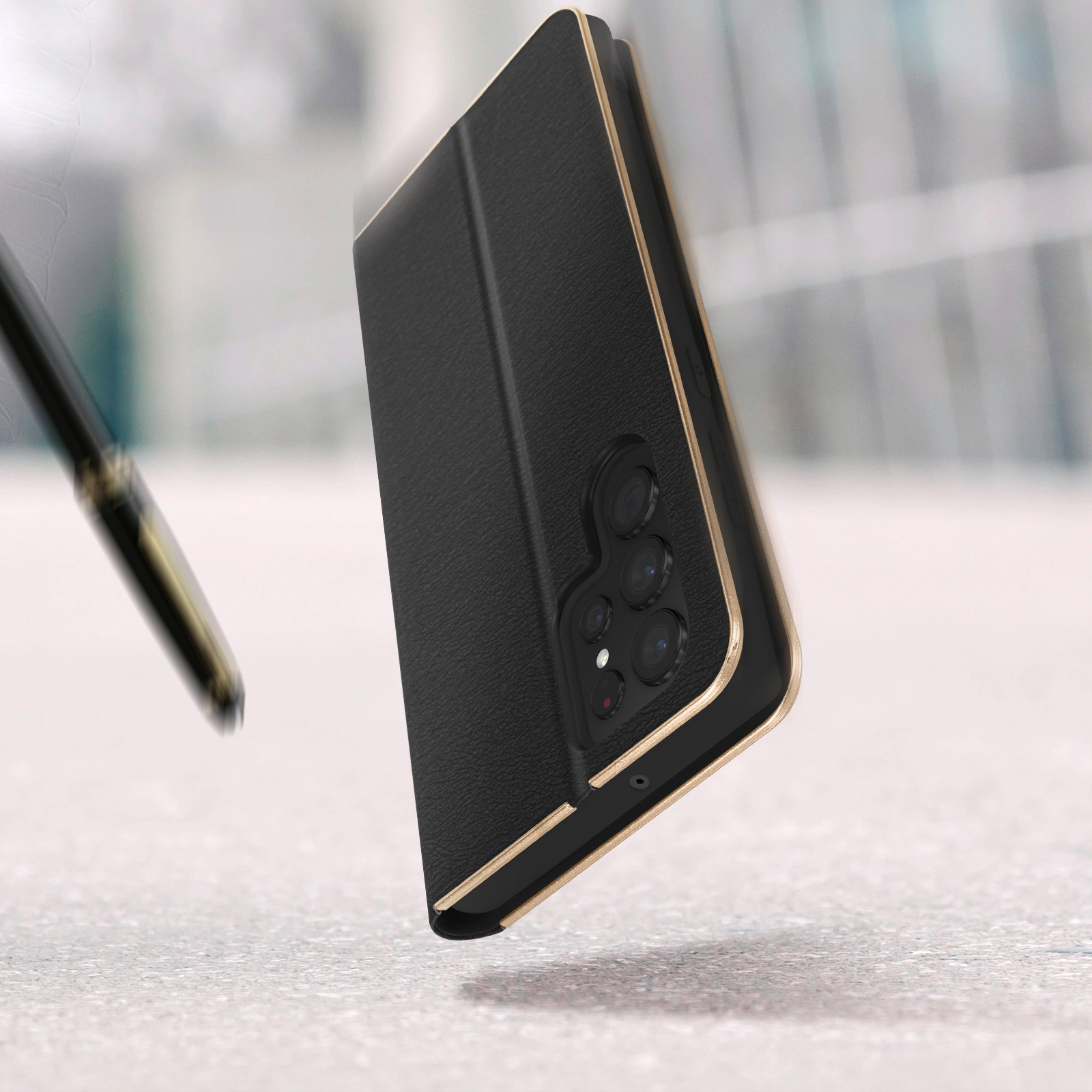 Custodia per telefono nera con finiture dorate, telefono all'interno. Una penna è a sinistra.