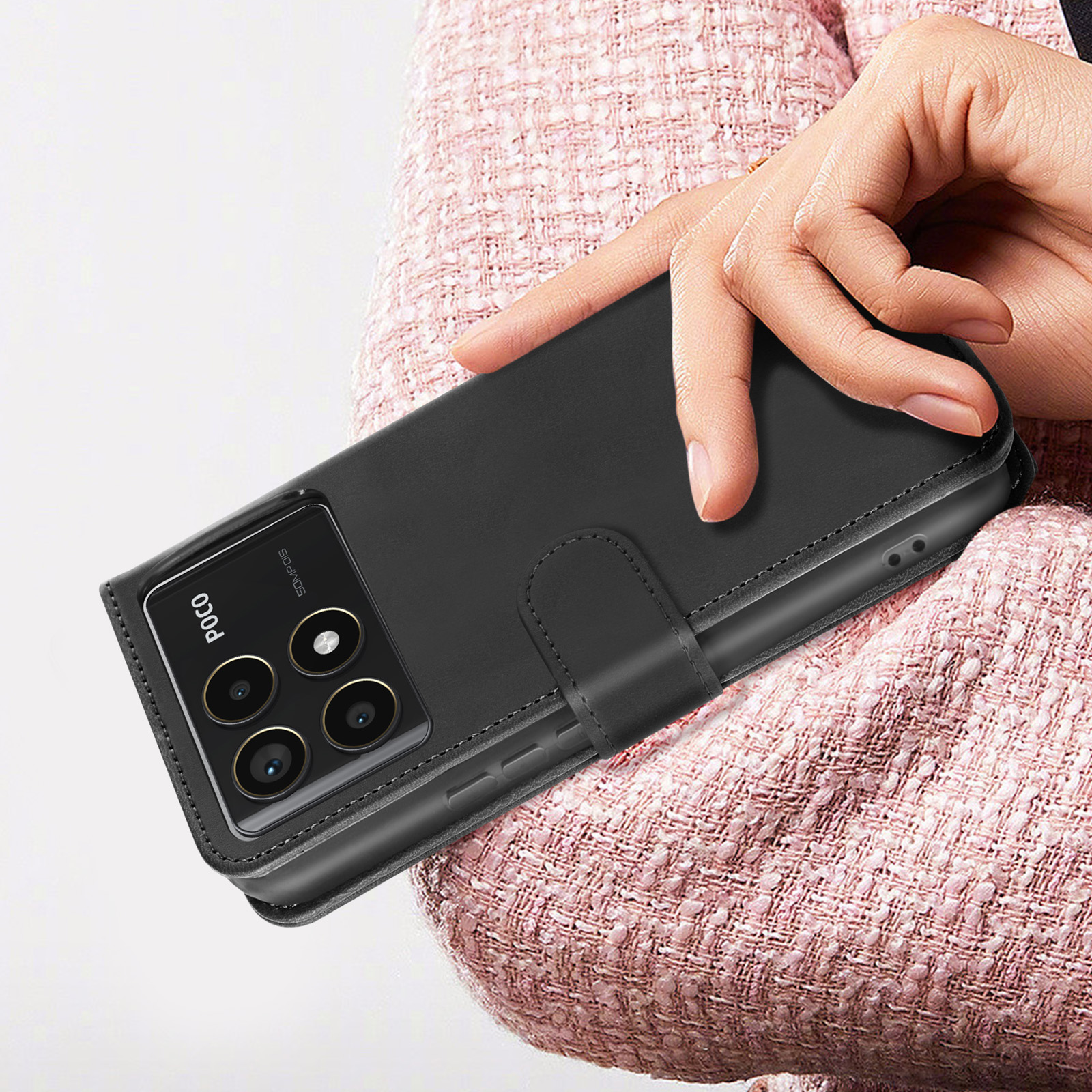 Hand hält eine schwarze Handyhülle mit Telefon. Handyhülle hat einen Magnetverschluss.