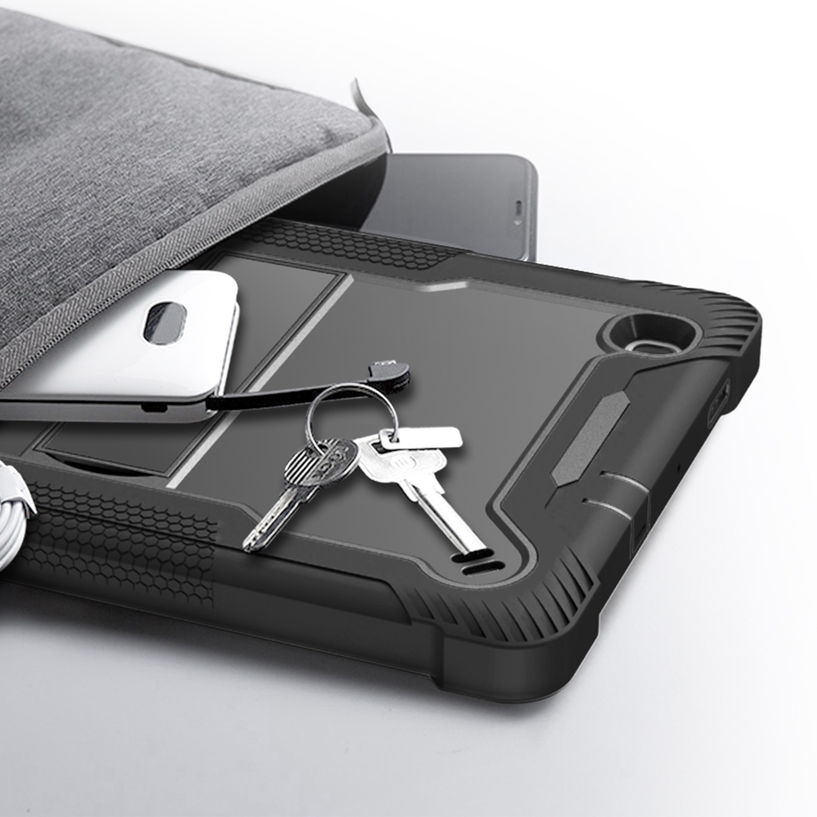 Tablet nero in una custodia nera, con chiavi e una borsa dietro. Cavo bianco visibile.