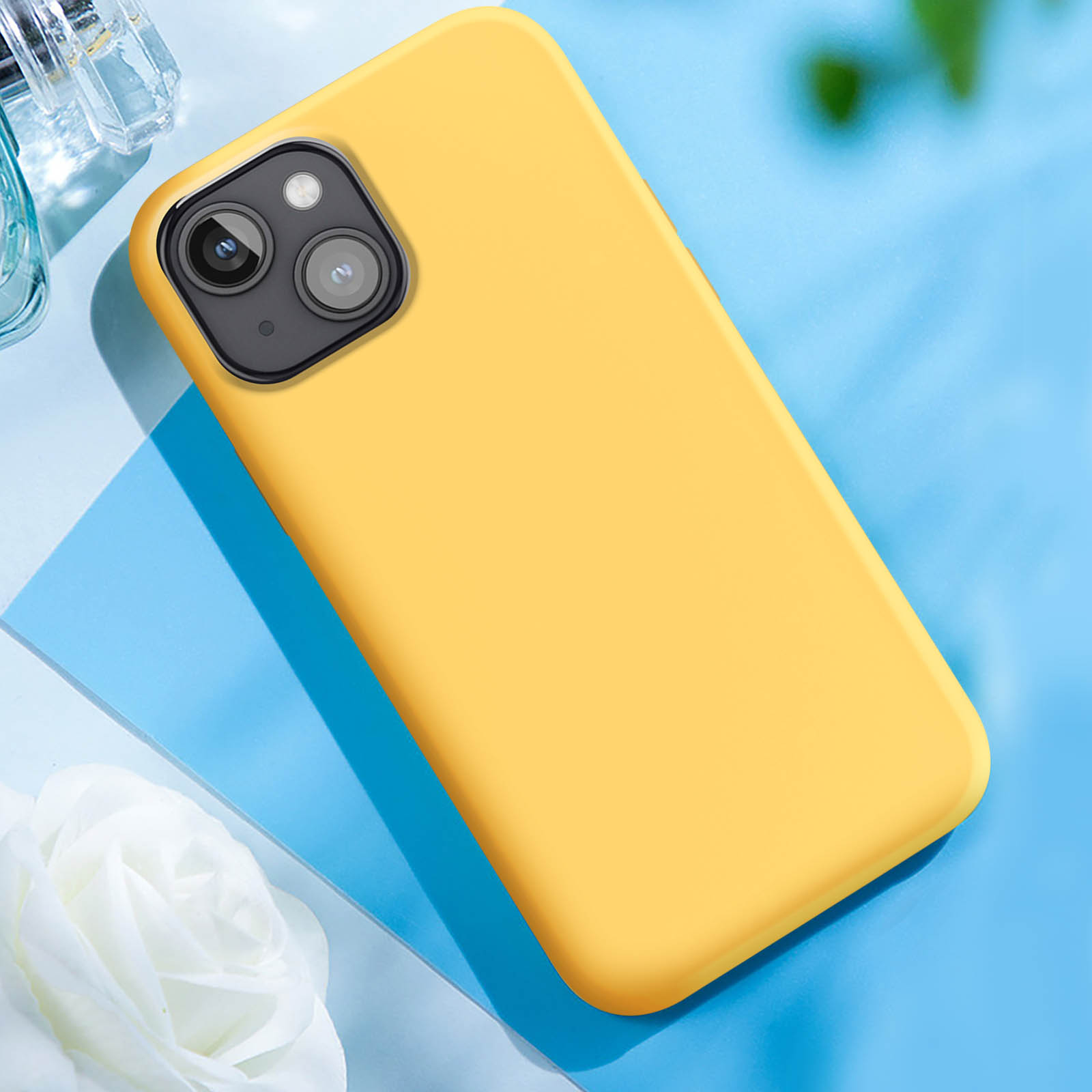 Custodia per telefono gialla su sfondo blu. La custodia copre la fotocamera del telefono.