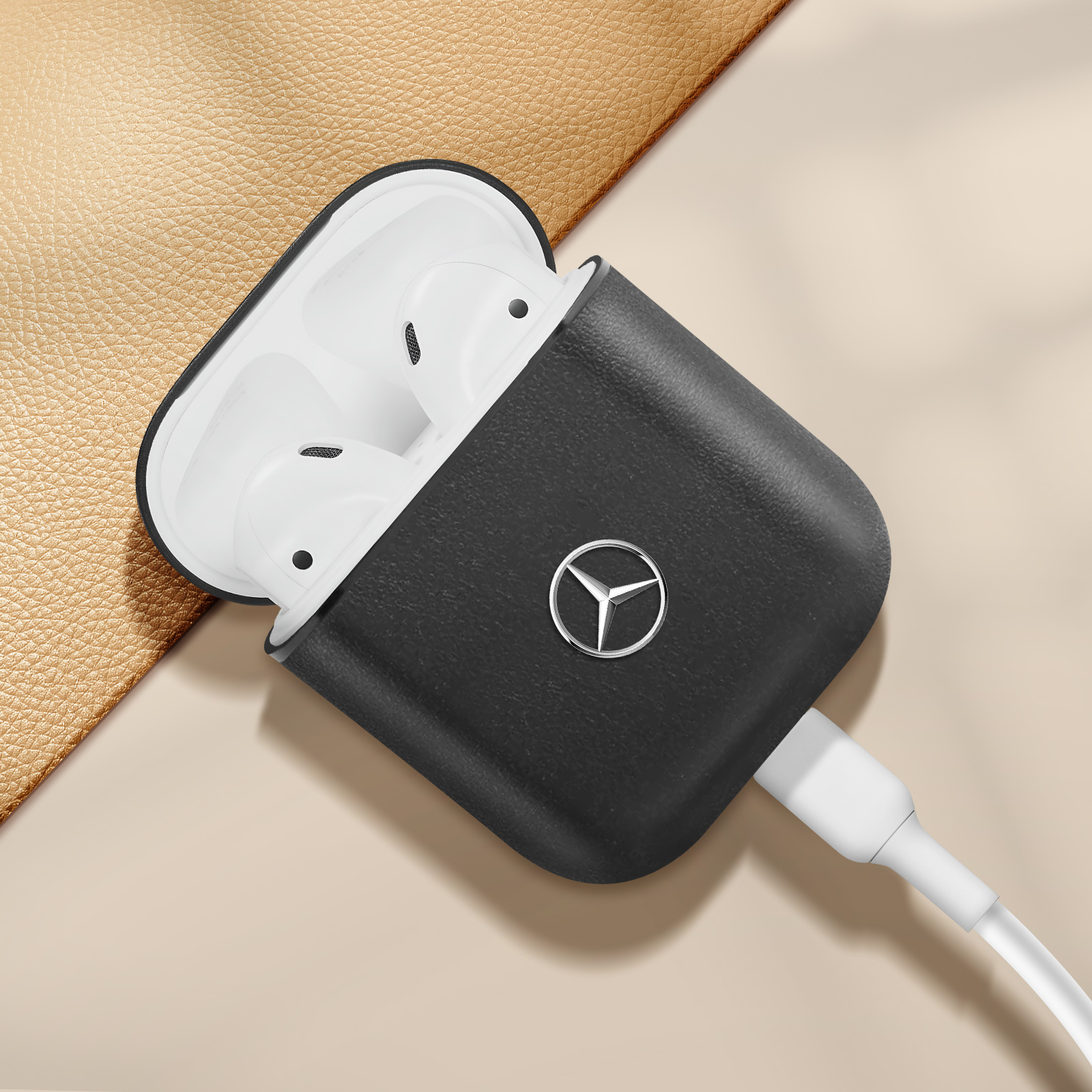 Funda negra con logo de Mercedes, sujetando auriculares blancos.