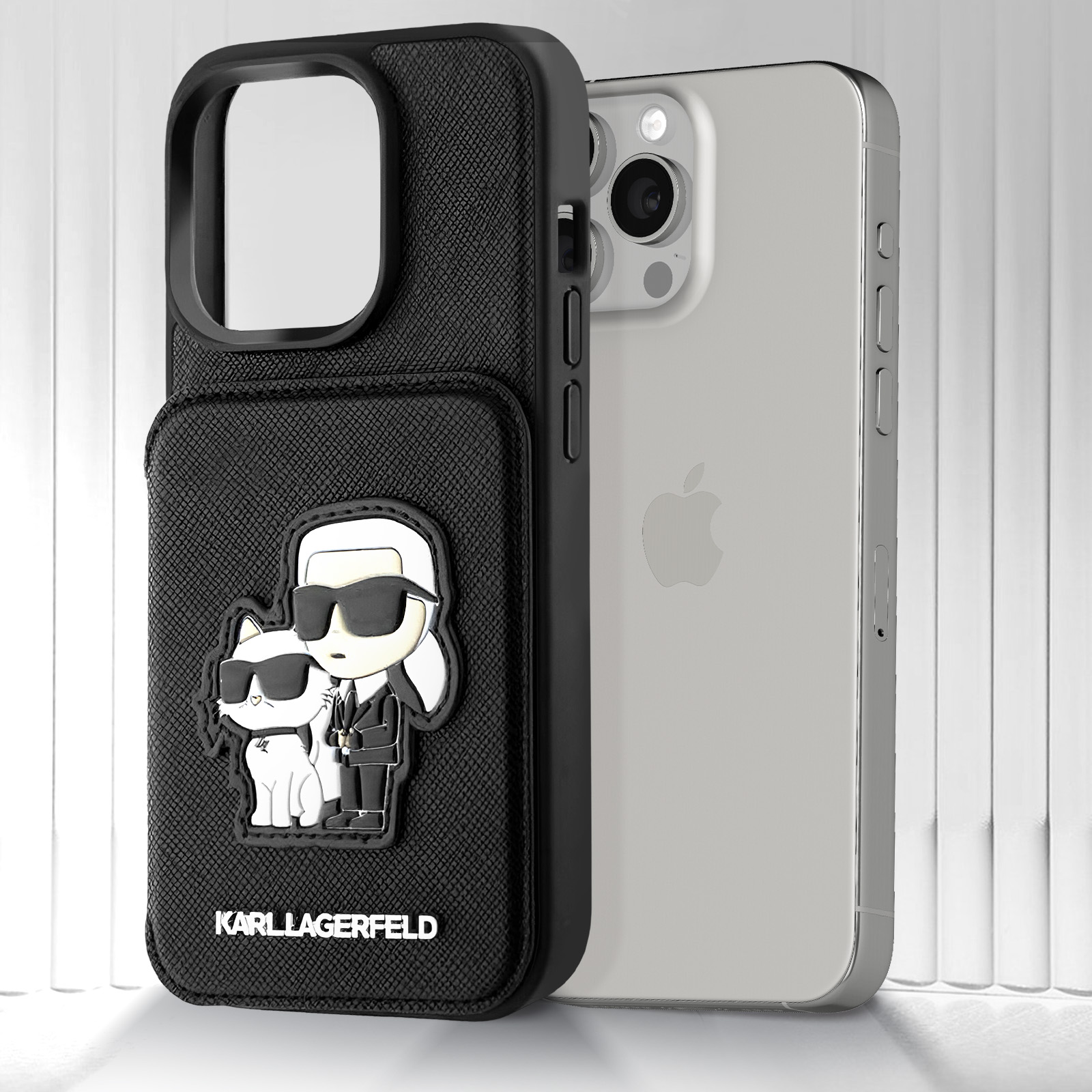 Karl Lagerfeld kedi tasarımlı siyah telefon kılıfı, yanında telefon.
