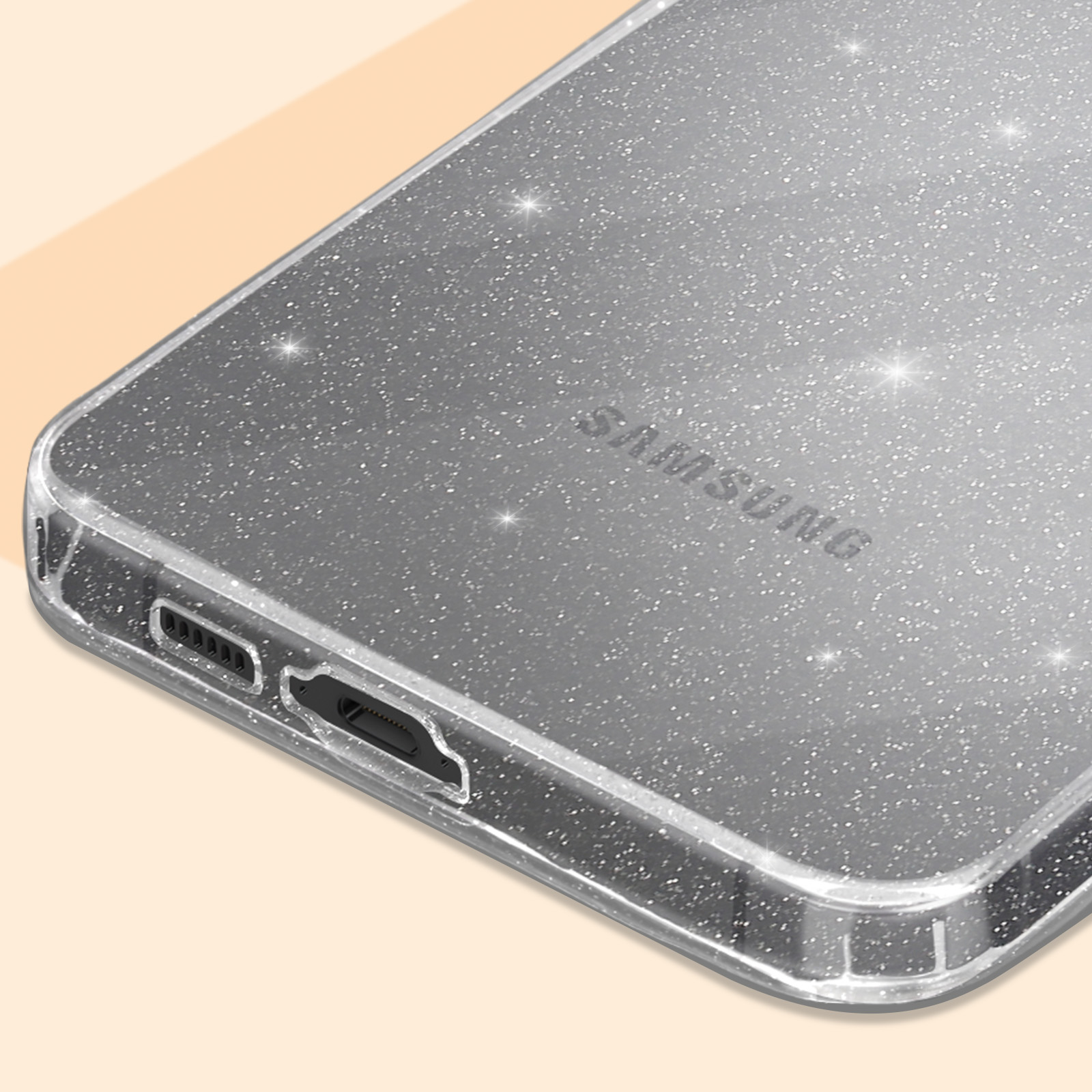 Una custodia per telefono argentata lucida con logo Samsung. La porta USB è visibile in basso.