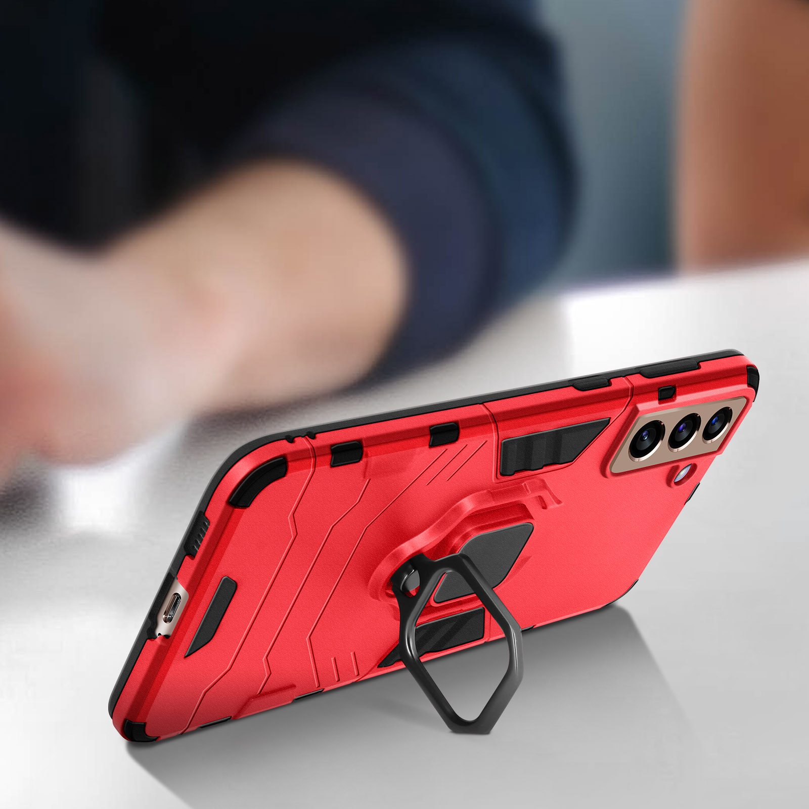 Custodia rossa per telefono con supporto ad anello, vista angolata, su superficie bianca.