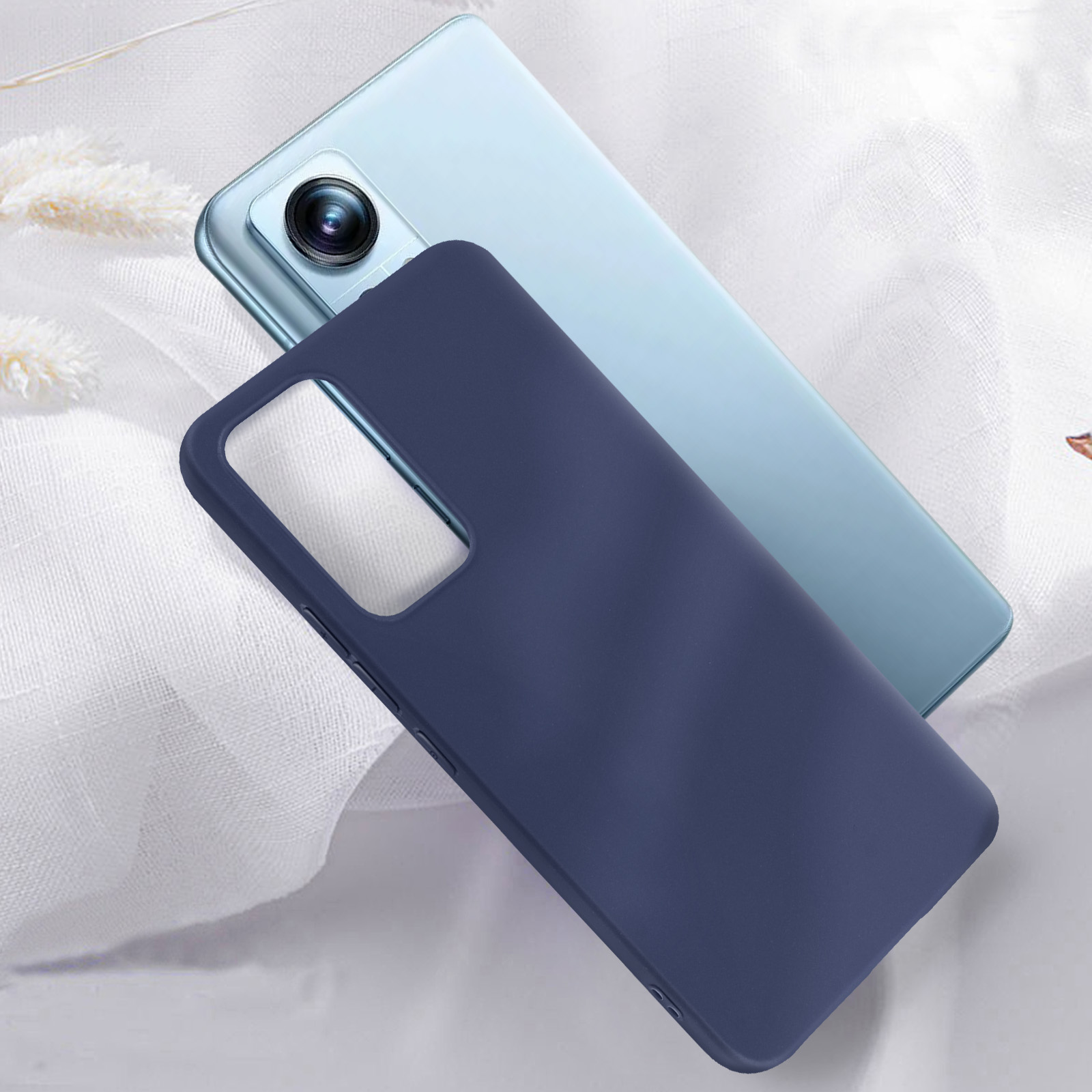 Custodia per telefono blu scuro su un telefono blu chiaro. Sfondo in tessuto bianco. Il telefono è nell'angolo.