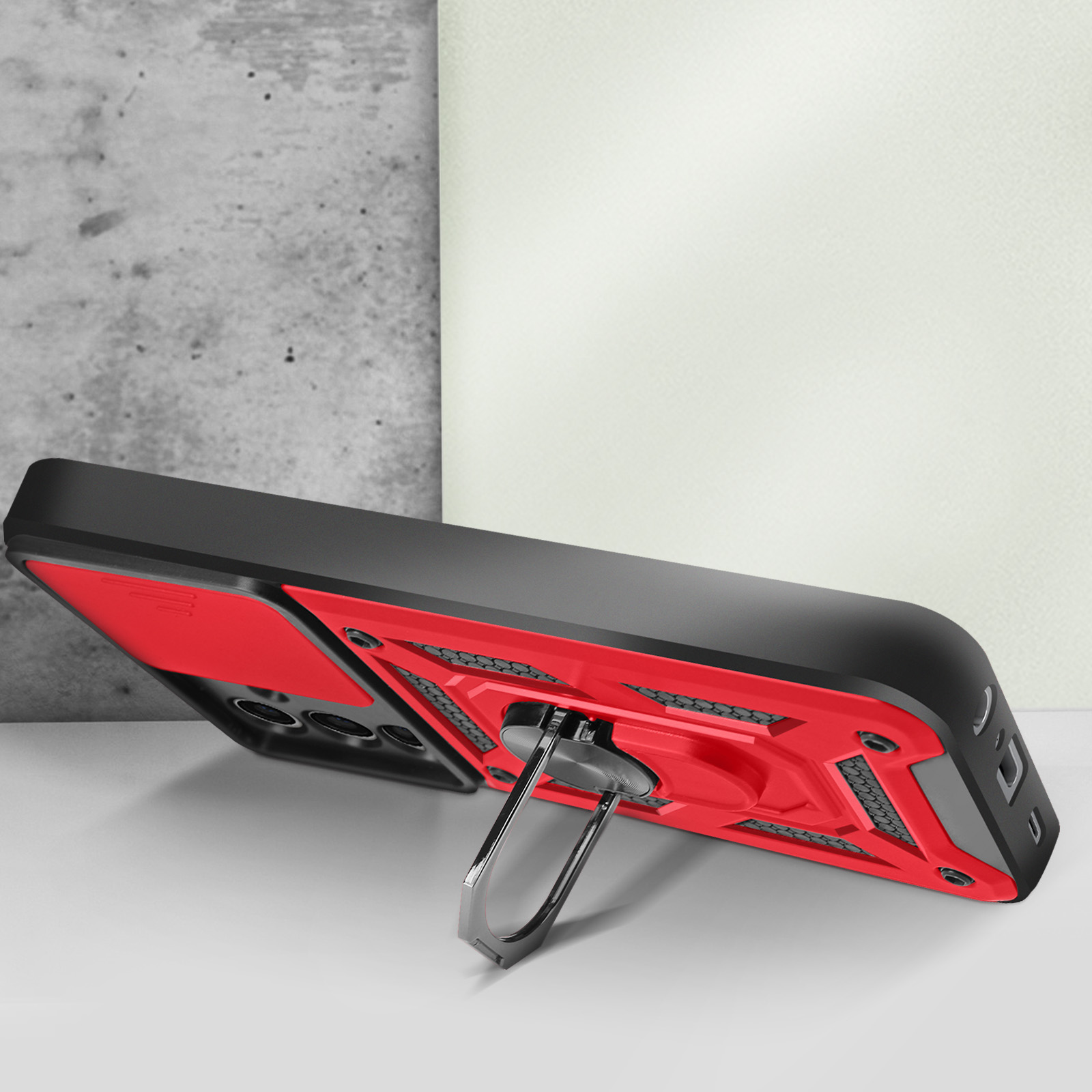 Funda negra y roja con soporte de anillo.