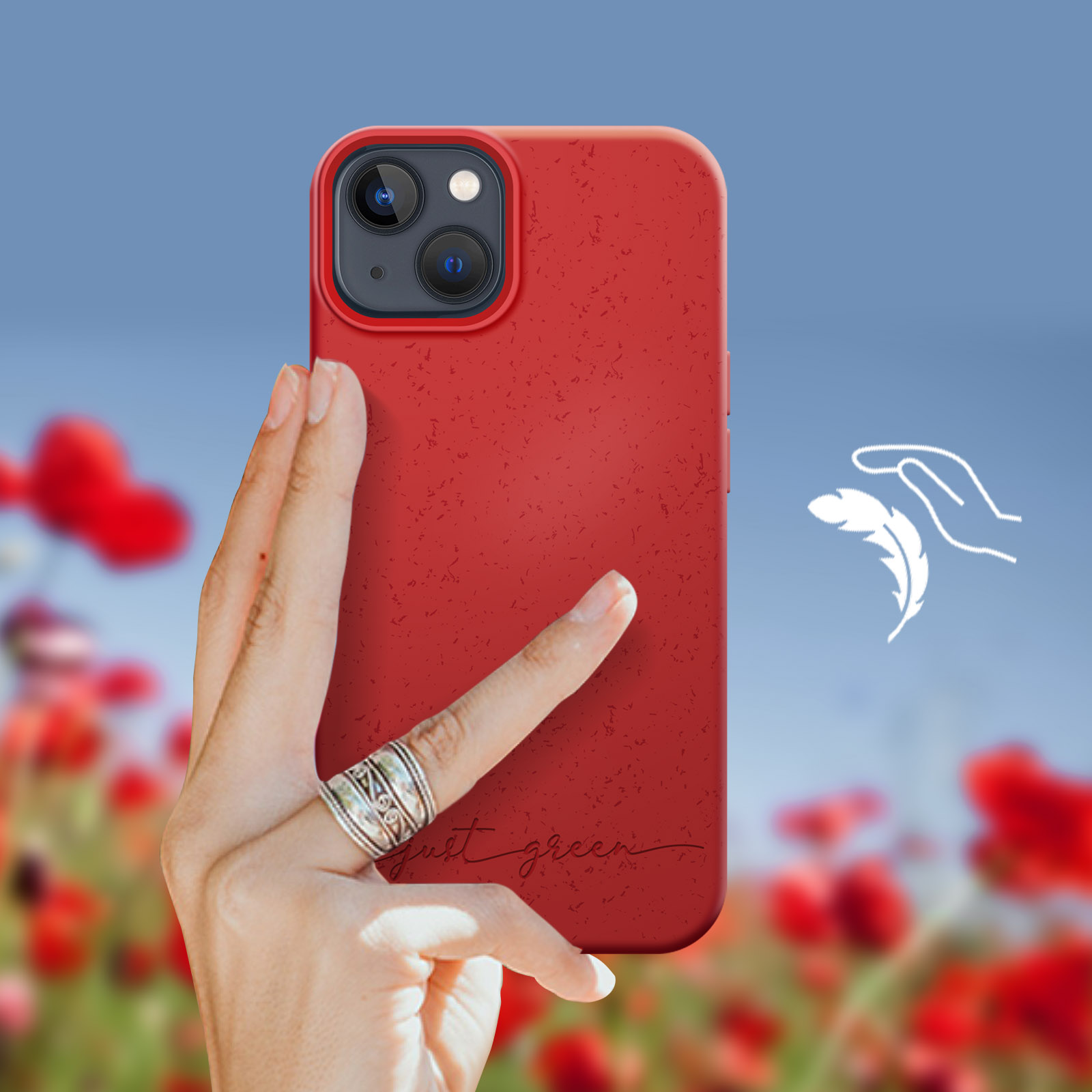 Una mano che tiene una custodia per telefono rossa davanti a un campo di fiori.