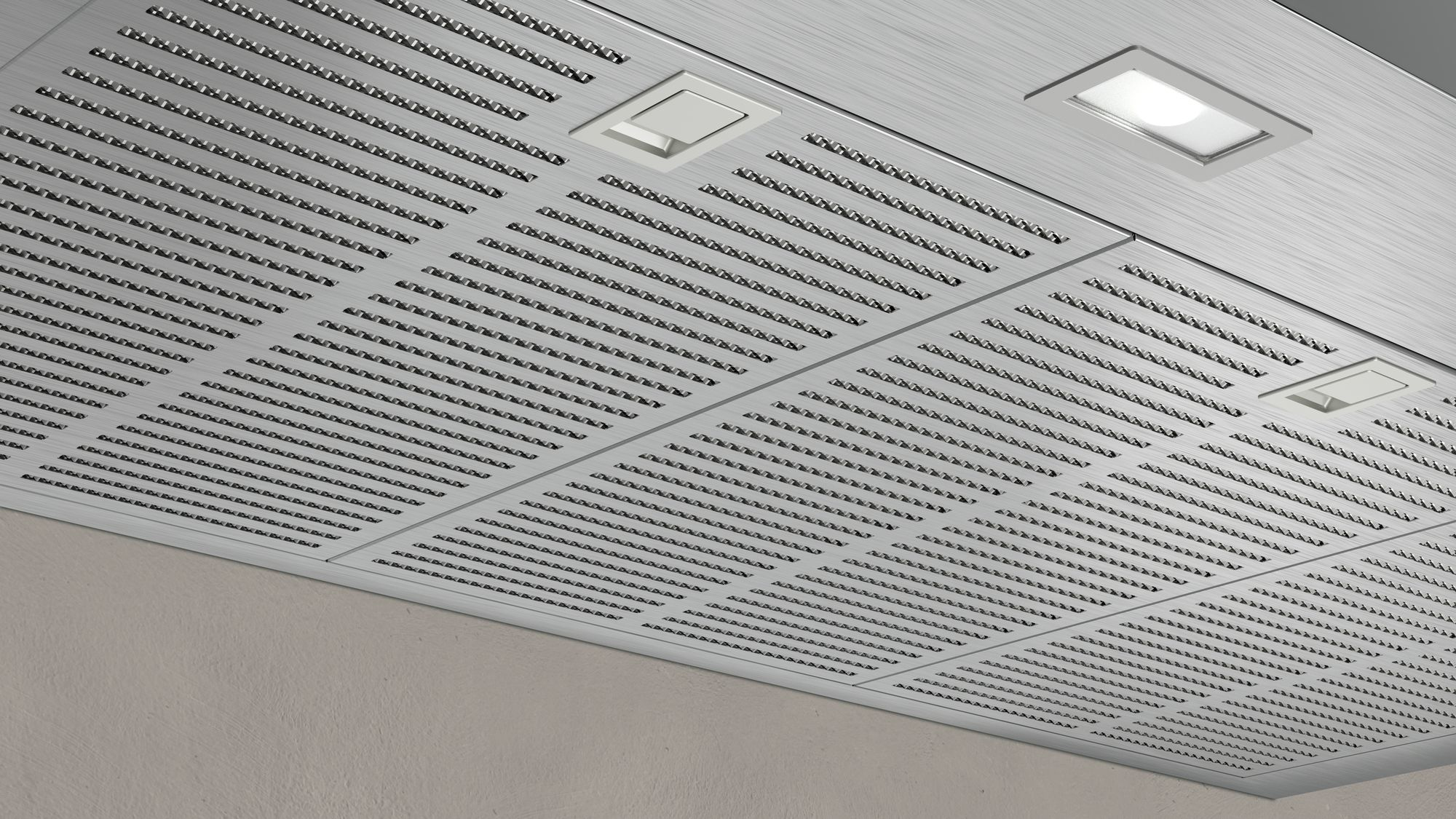 A silver metal ceiling with perforated panels and recessed lighting.