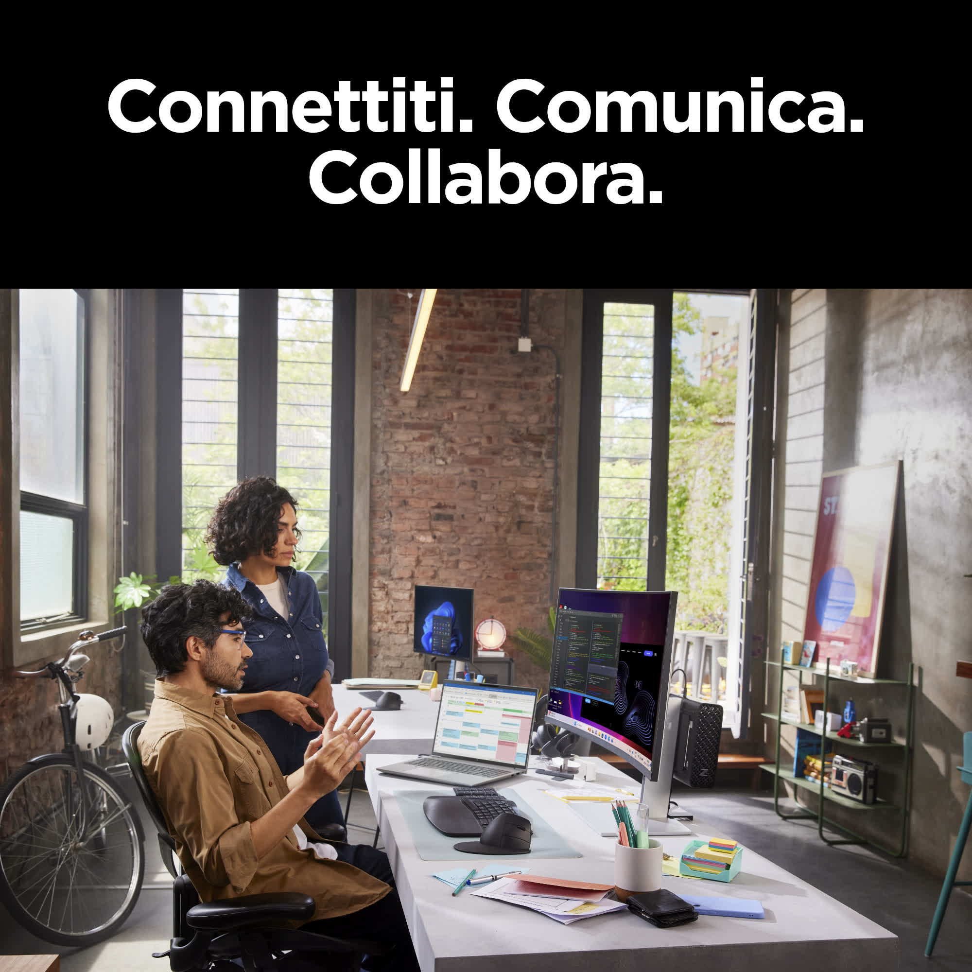 Persone che lavorano in un ufficio. Un uomo e una donna guardano uno schermo di computer.