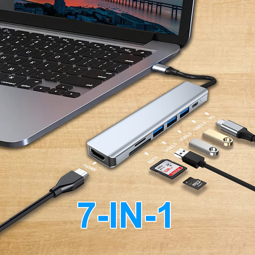 Silberner USB-Hub mit angeschlossenen Geräten, einschließlich SD-Karte, USB-Laufwerken und einem Laptop.