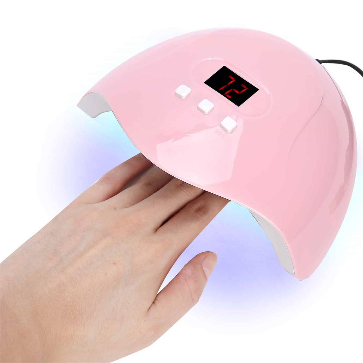 Ein rosa Nageltrockner mit einer Hand darin, die Nägel trocknet.