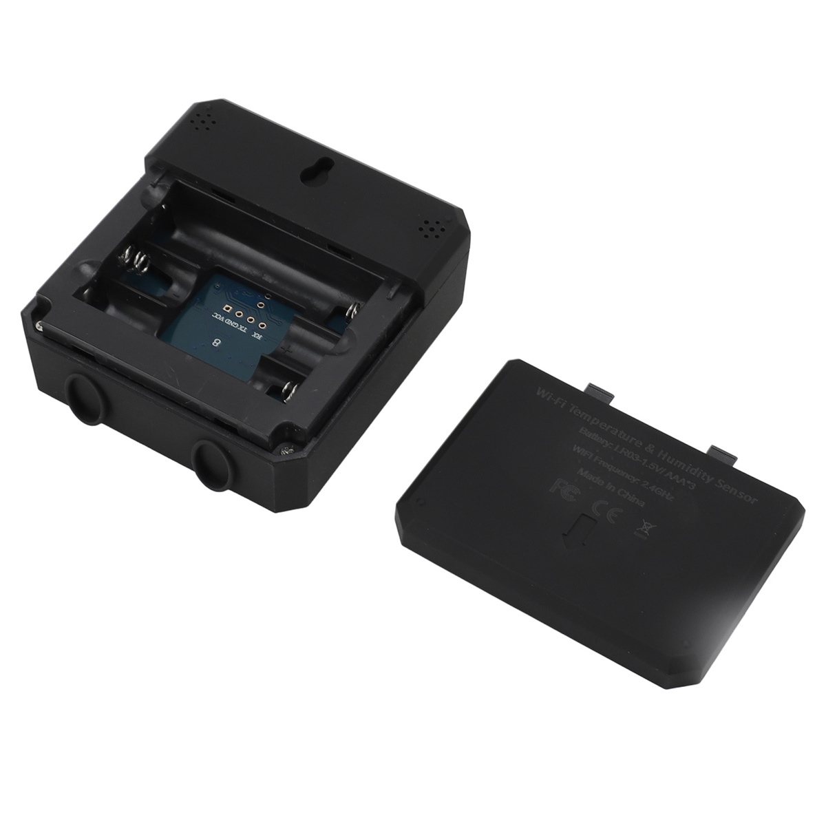 Ein schwarzes Gerät mit offenem Batteriefach. Das Gerät hat eine Platine und einen Deckel daneben liegend.