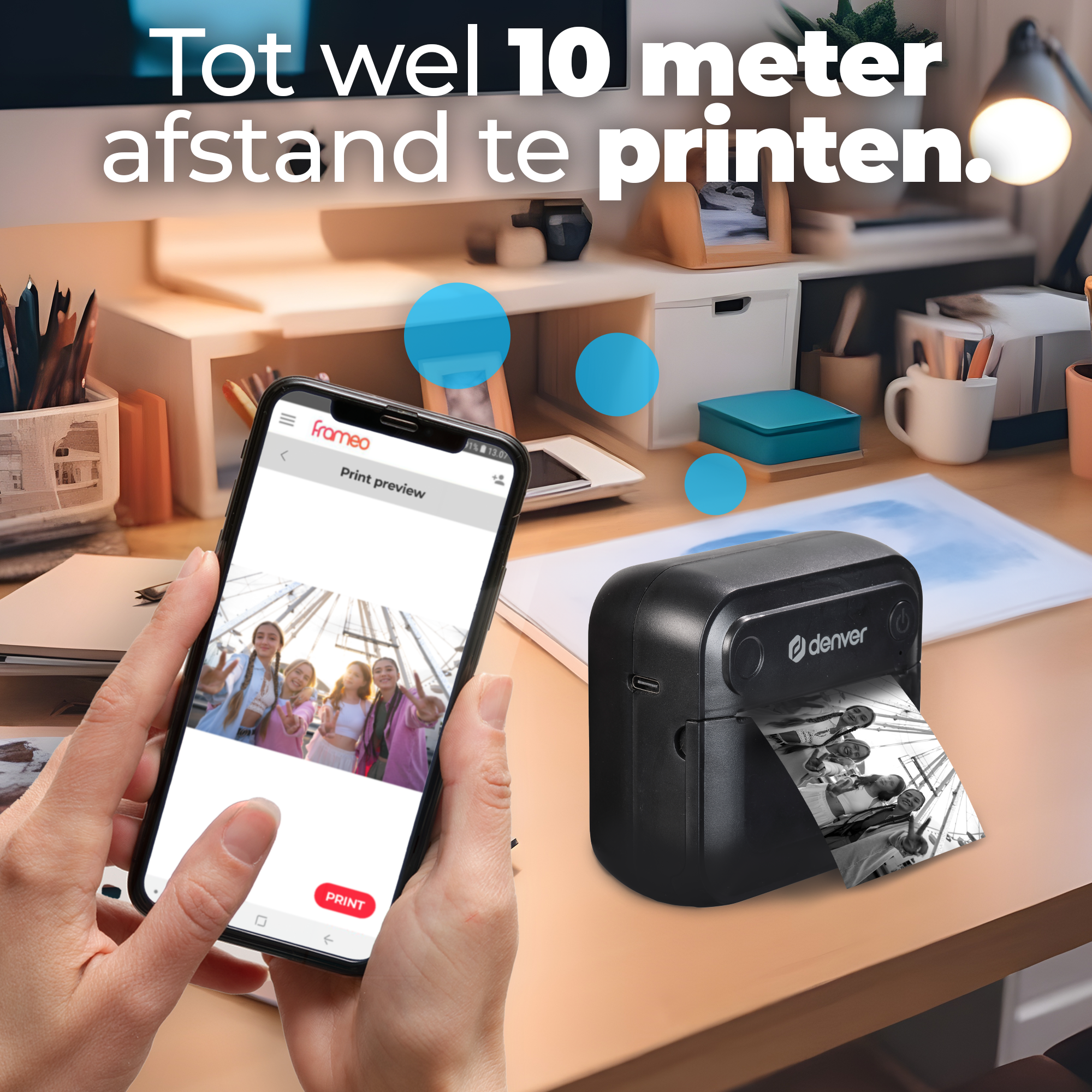 A smartphone showing a photo being printed by a small black printer on a desk.