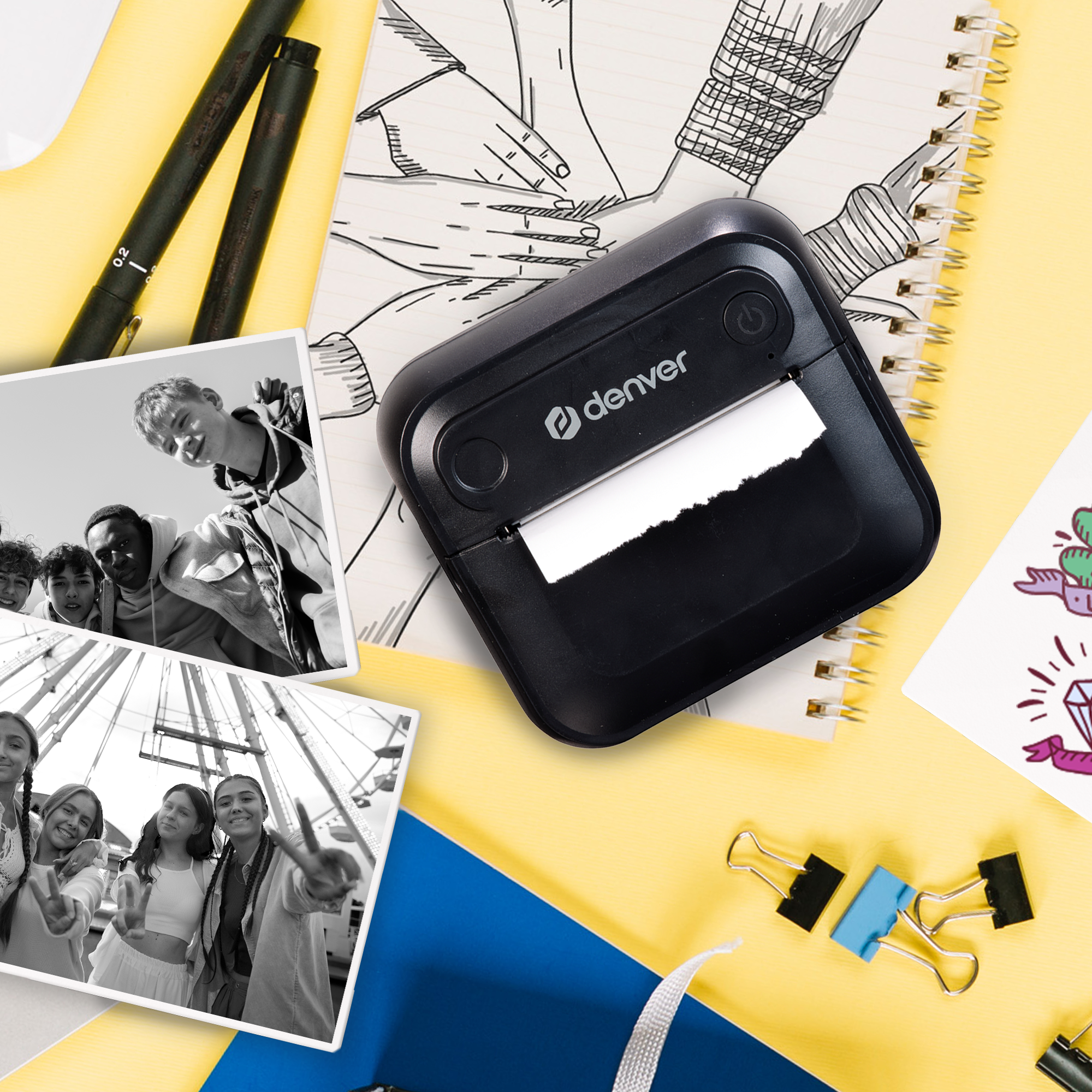 A black printer with other items on a yellow and blue background.