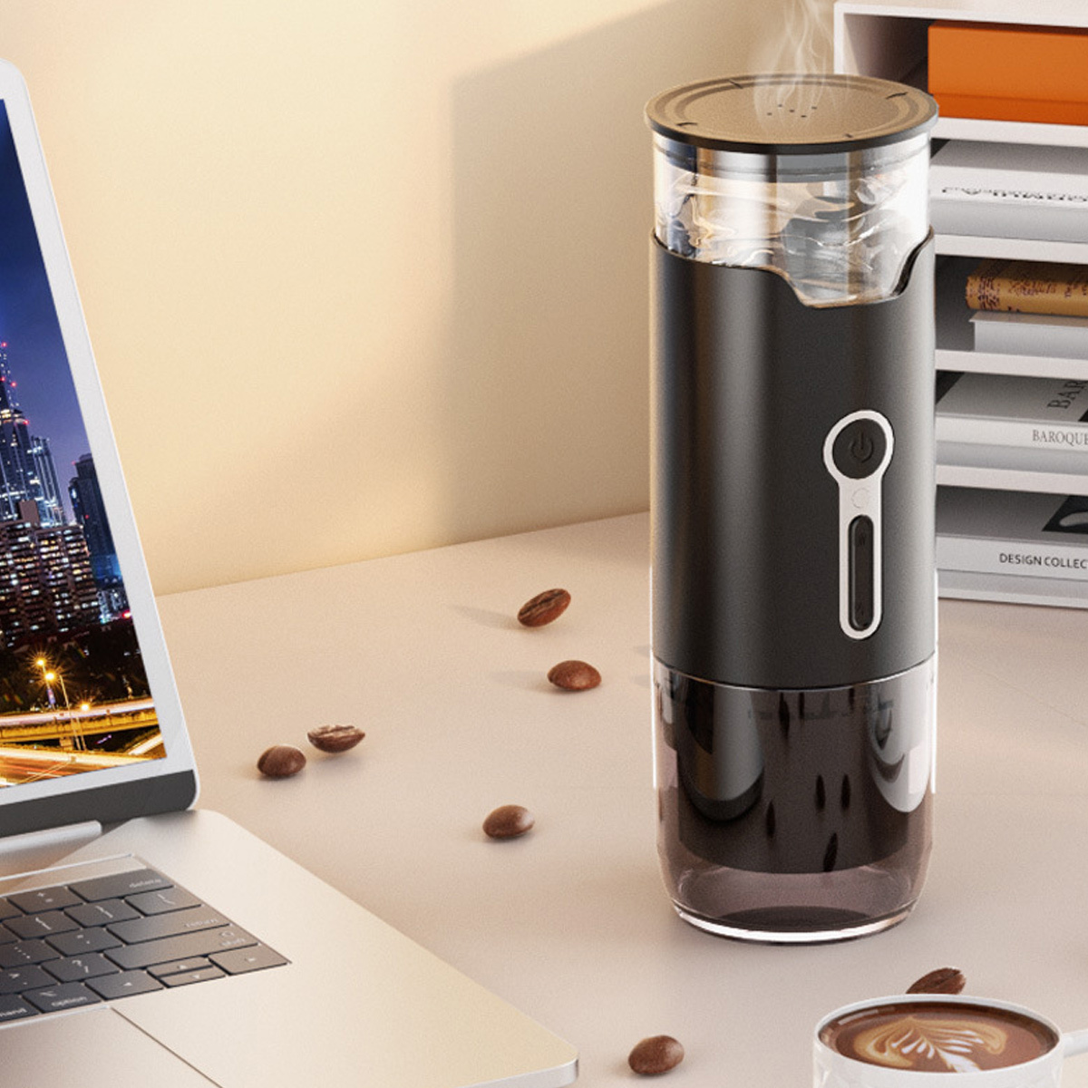 Schwarze Kaffeemühle mit Kaffeebohnen auf einem Schreibtisch. Laptop ebenfalls auf dem Tisch.