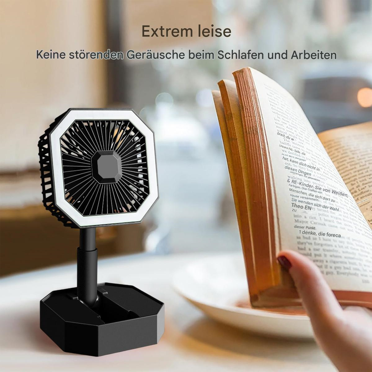 Schwarzer Ventilator mit LED-Lichtring und Buch im Hintergrund.