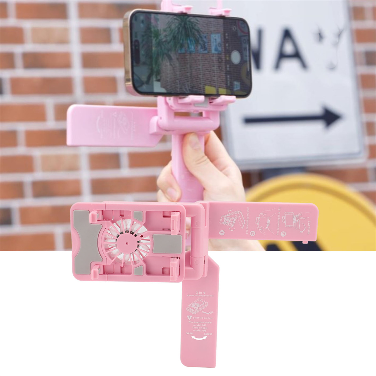 Rosa Telefonhalter mit Telefon, vor einem Schild und einem Gebäude.